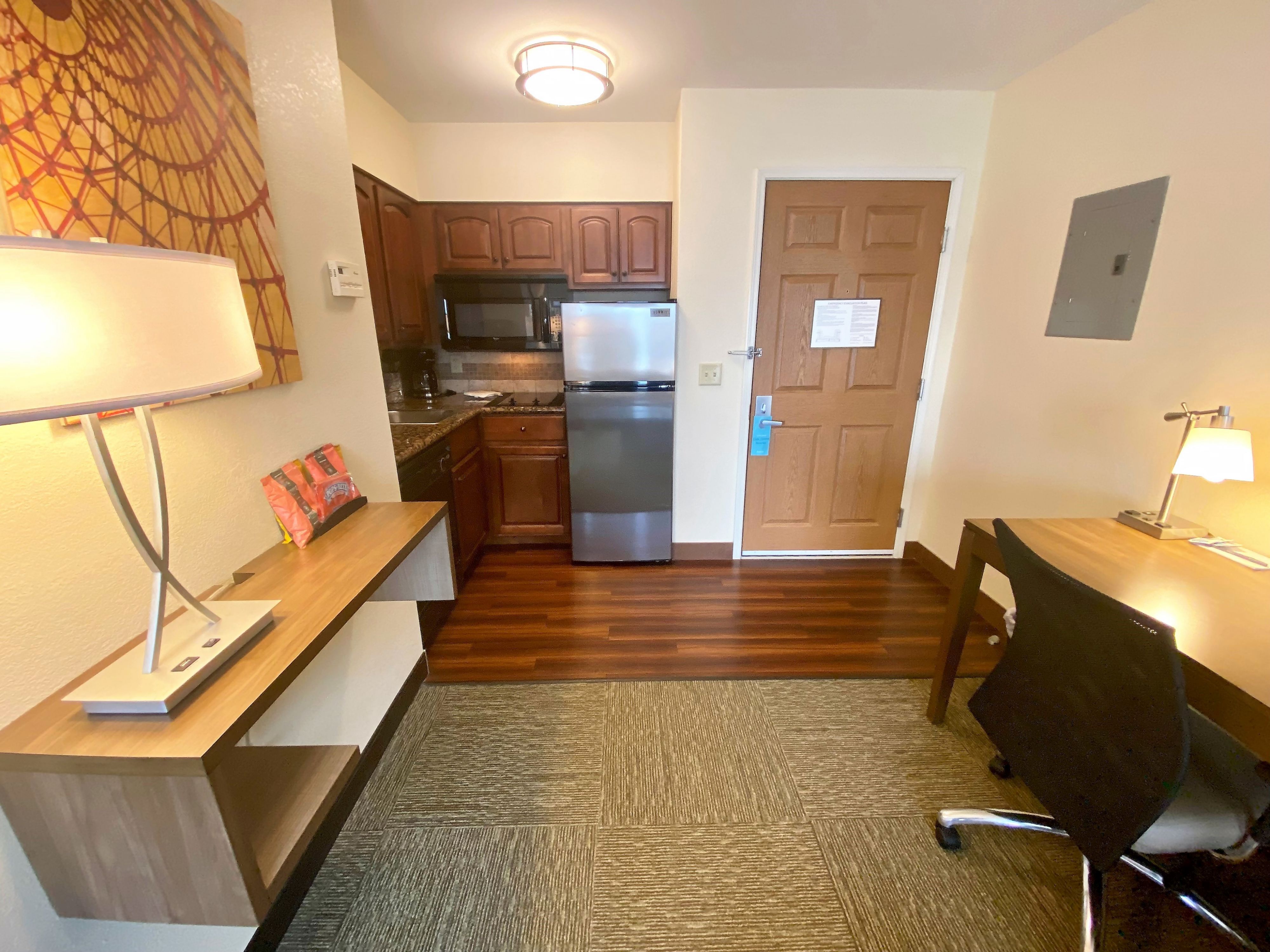 image Prepare meals effortlessly in this well-equipped kitchen, just steps from your workspace.