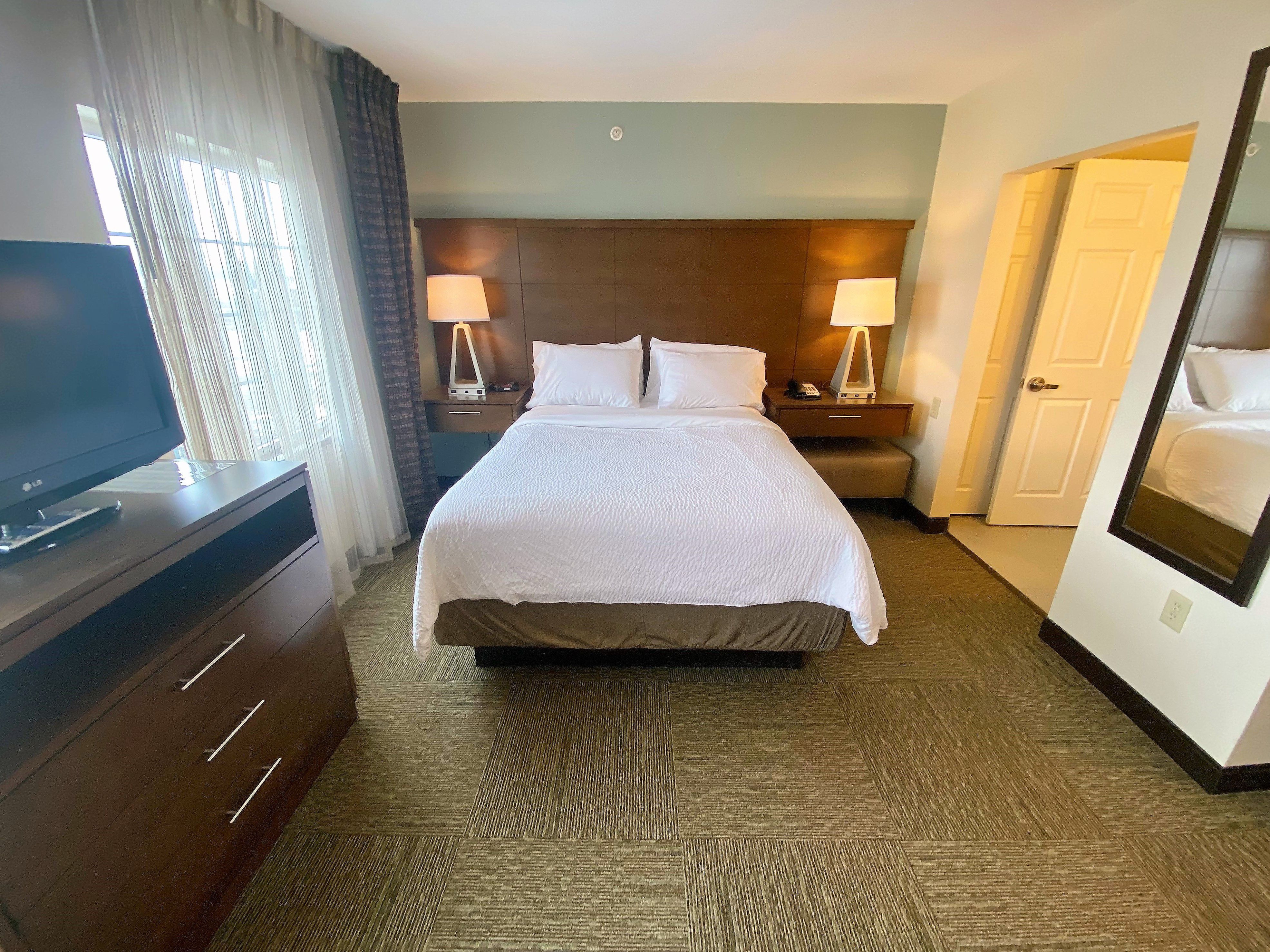 image Experience restful nights with plush bedding and natural light in your private retreat.