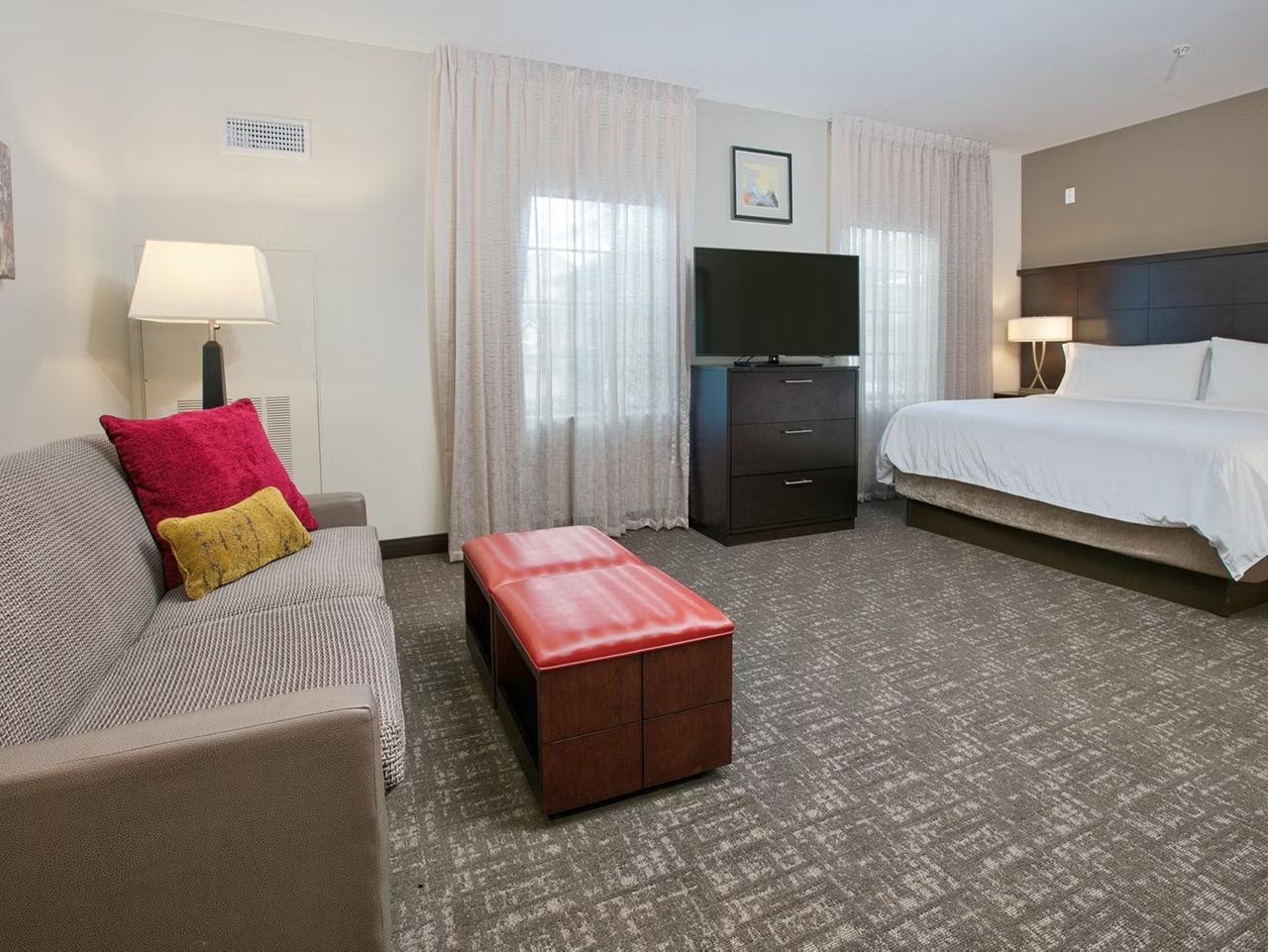 image Studio with bed, a seating area, and TV for relaxing evenings
