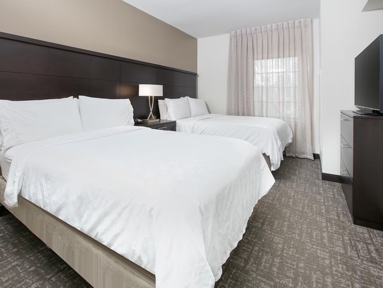image Two double beds with bedside lamps for a restful night's sleep