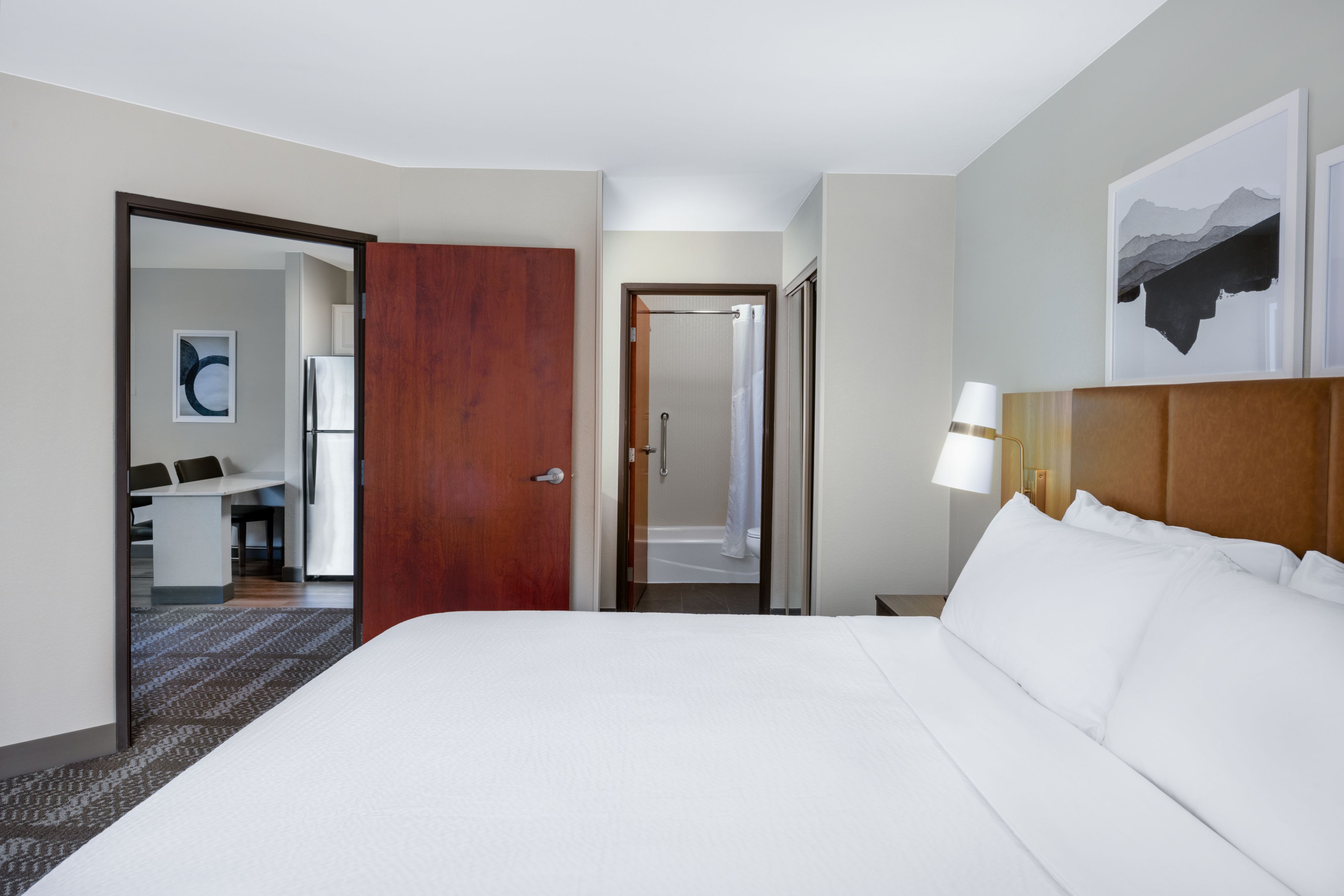 image Queen bedroom with decorative lamp and en suite bathroom.