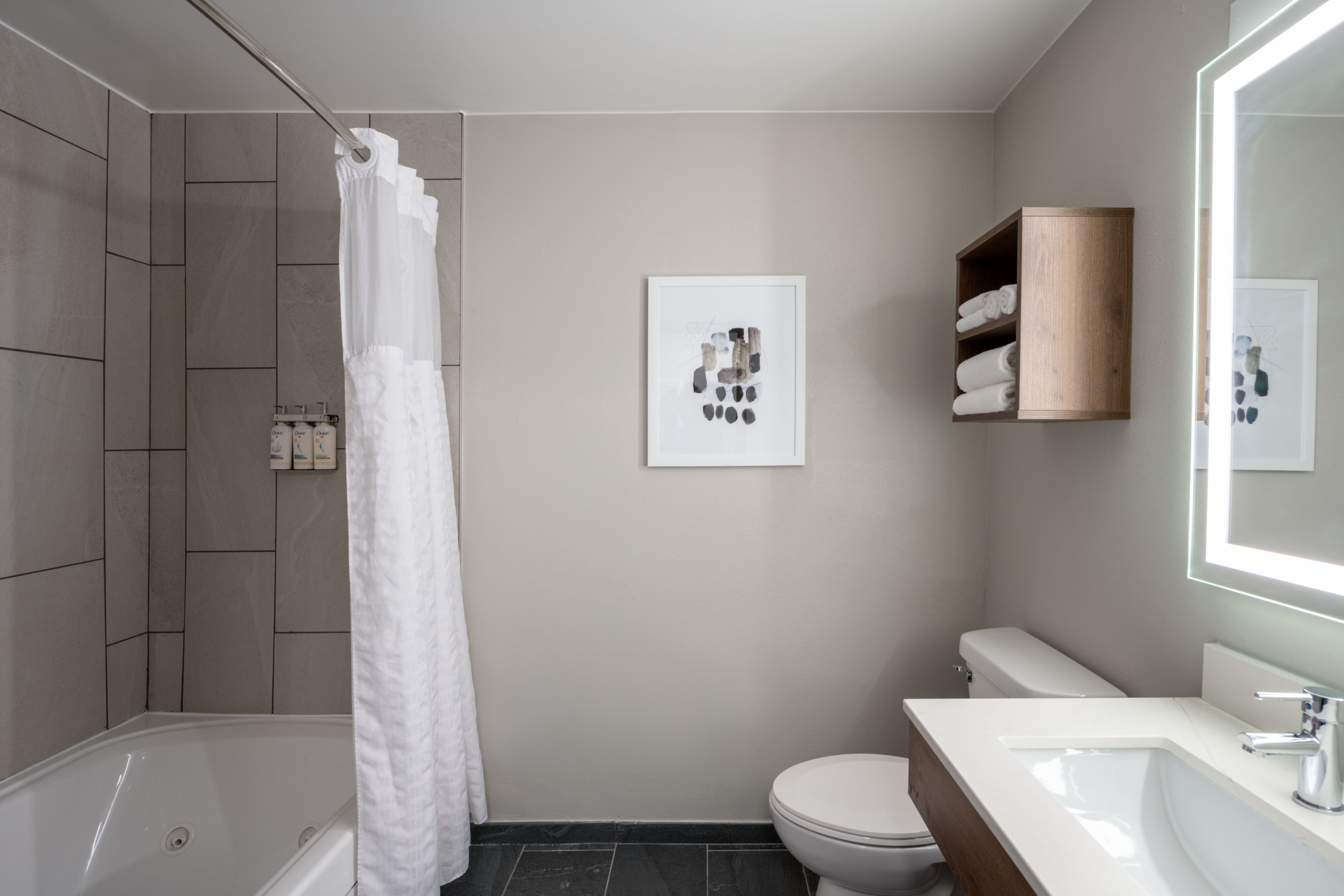 image Bathroom with walk-in shower, towels, and modern decor.