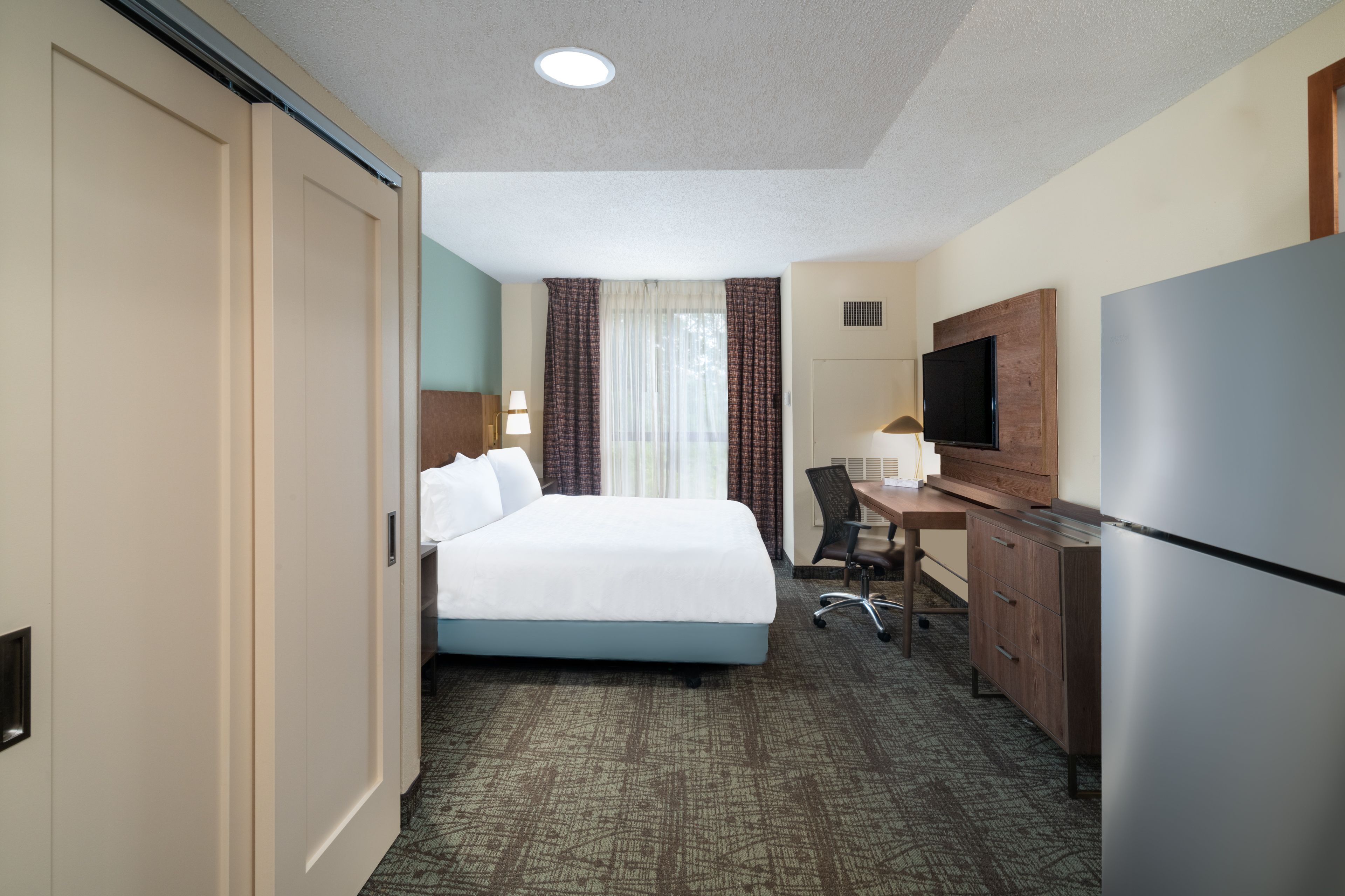 image Cozy king bed studio with dedicated work desk area.