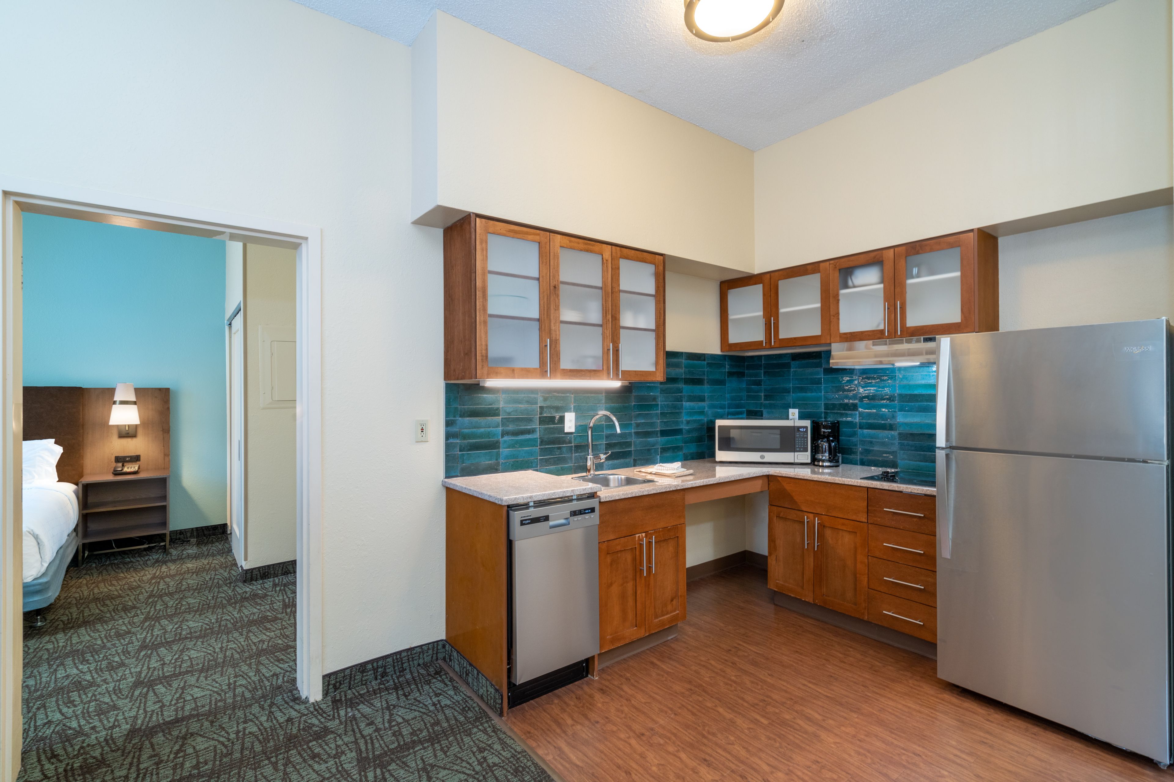 image Fully equipped kitchen with modern cabinetry and stainless appliances.