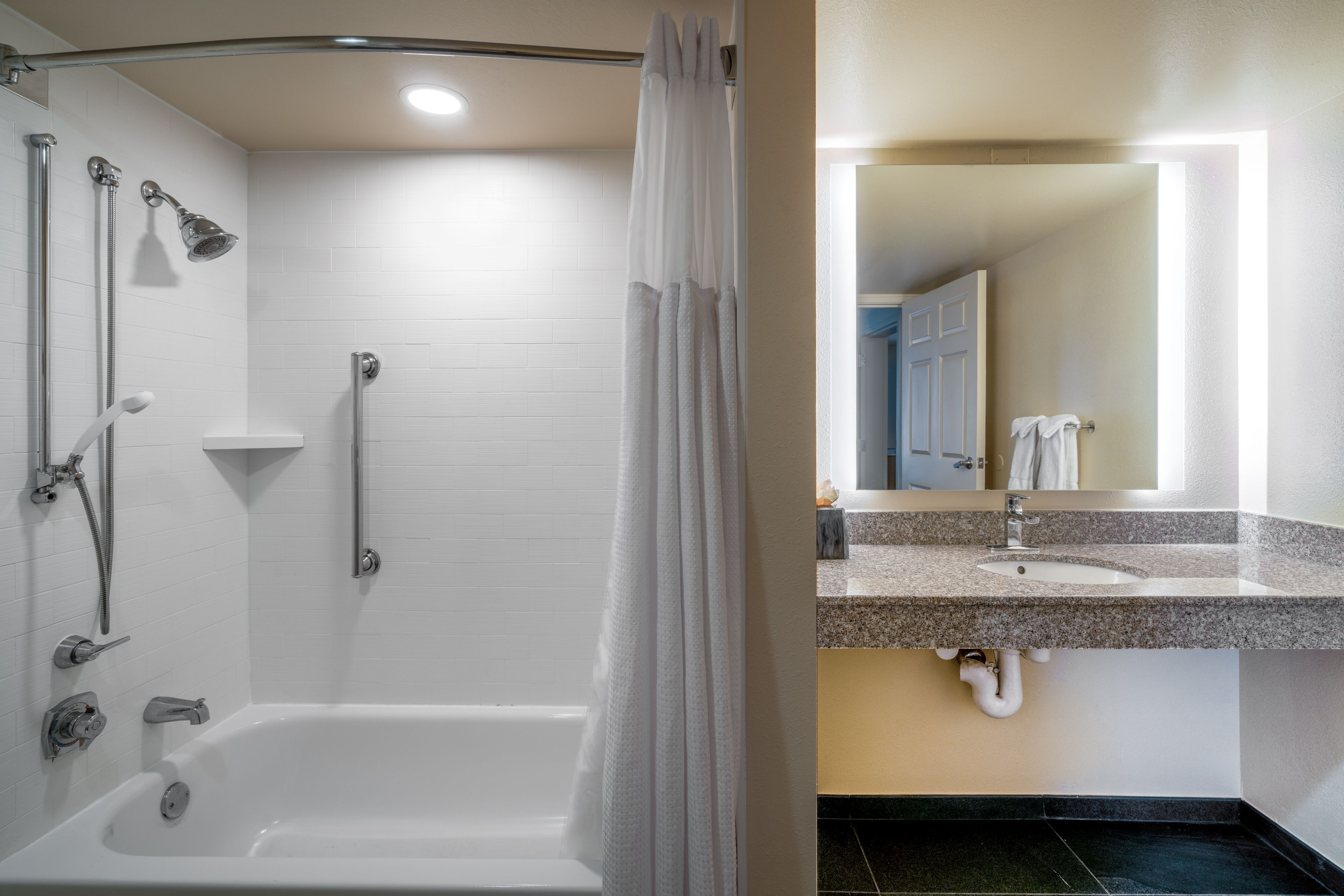 image Accessible bathroom featuring a full bathtub with modern fixtures.