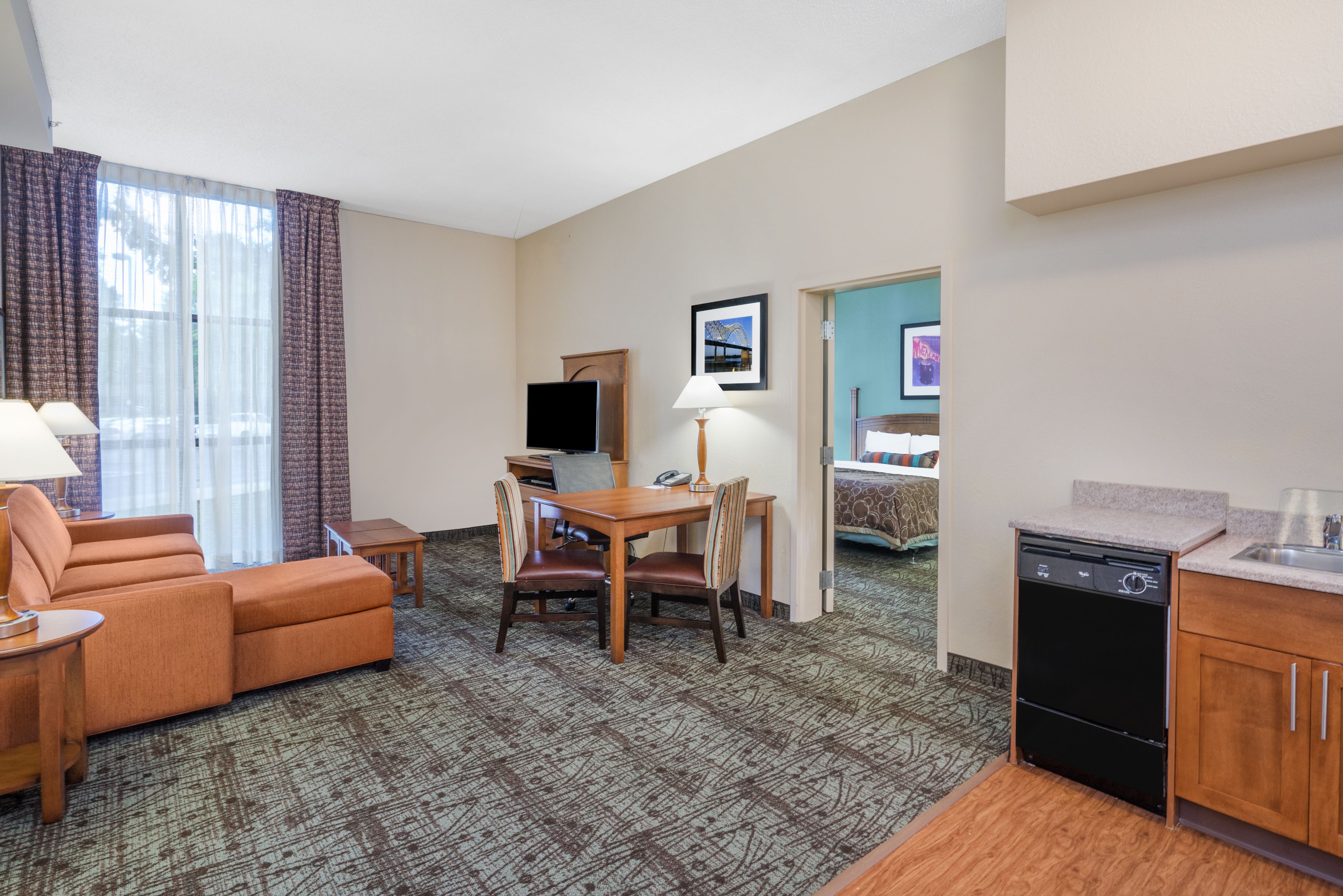image Spacious one-bedroom suite with open living area and kitchenette.