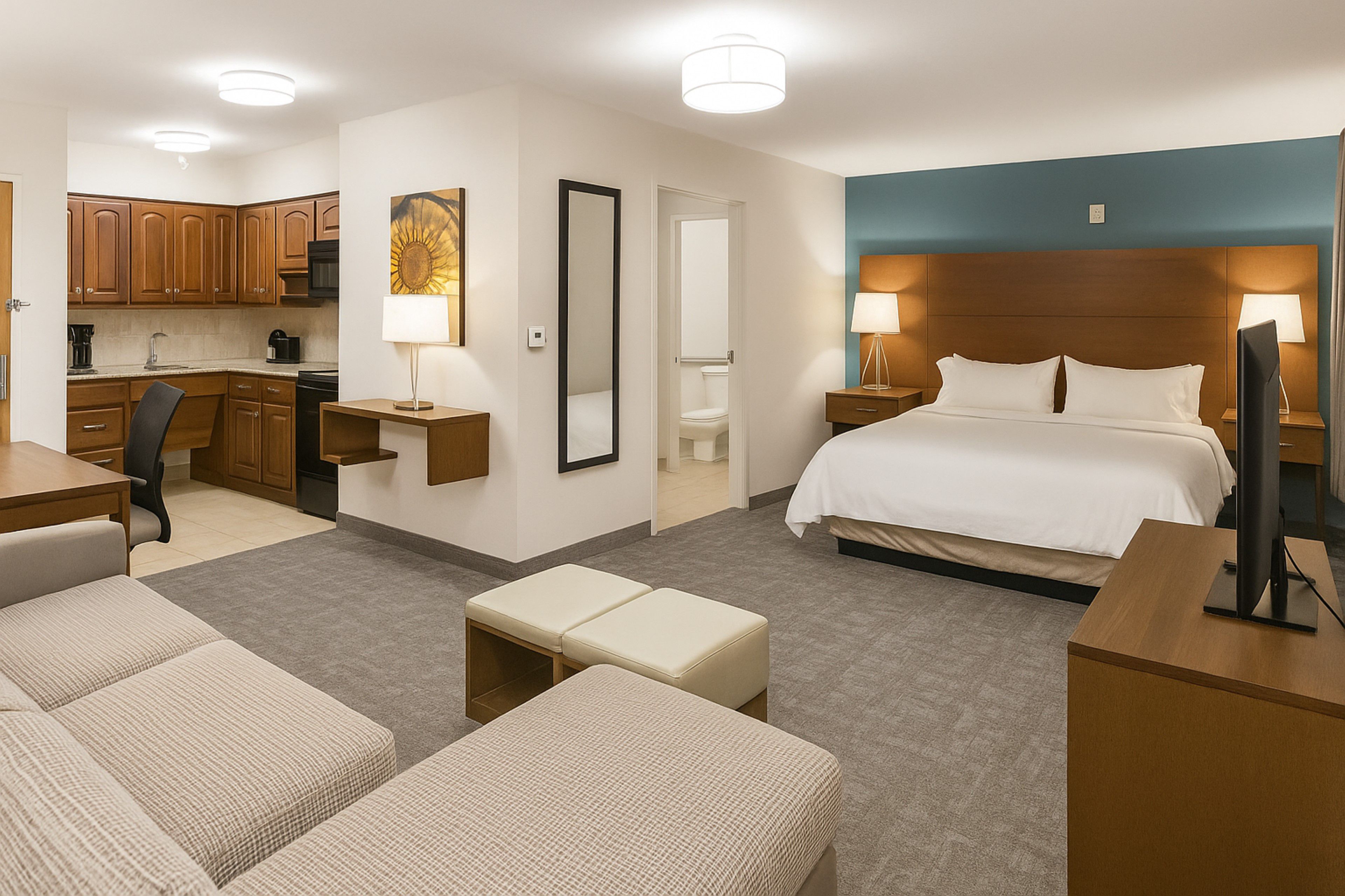 image Spacious king studio with full kitchen, sofa, seating area, and dining space.
