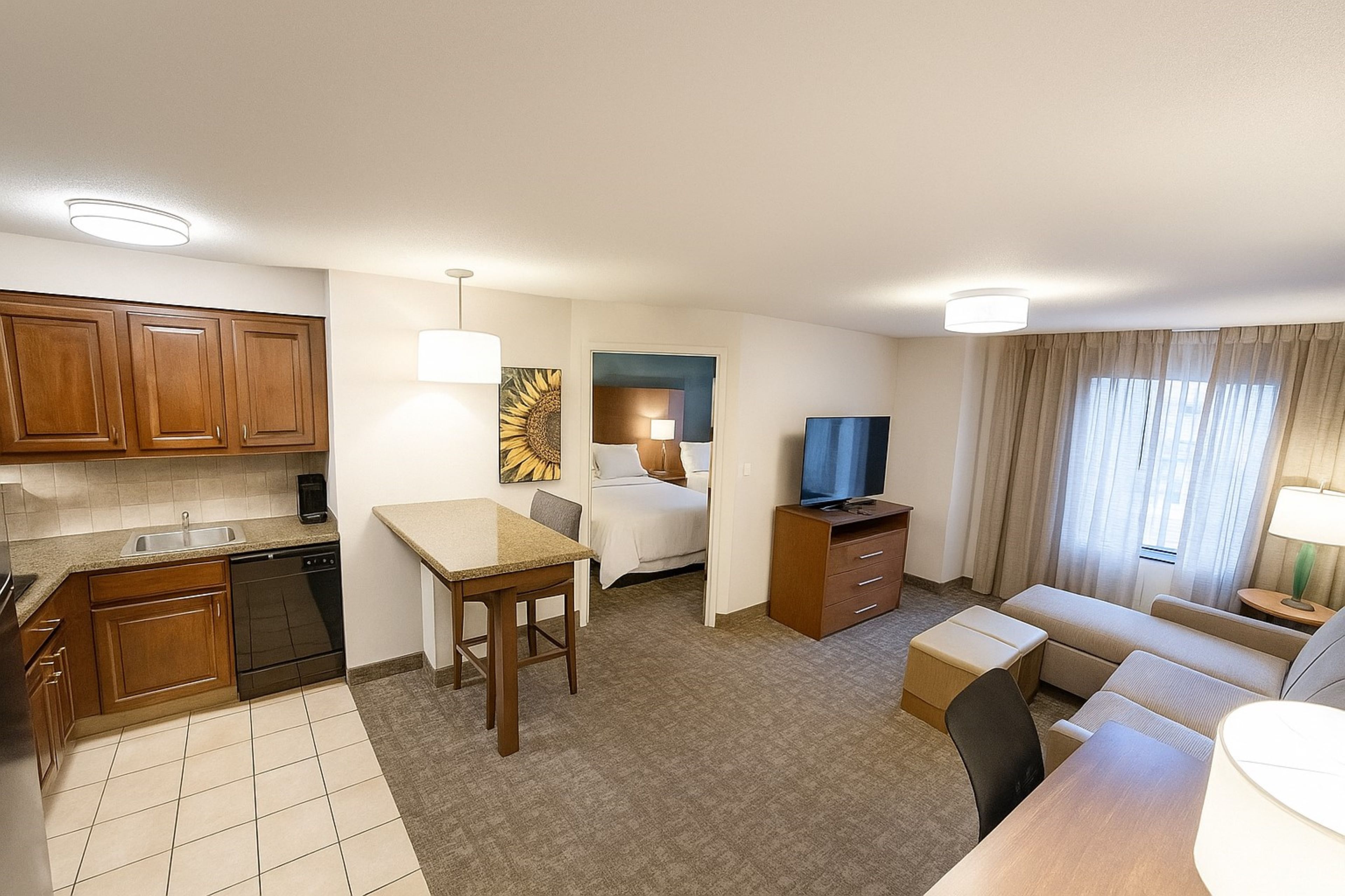 image Spacious living area with kitchen, dining table, and comfortable seating.