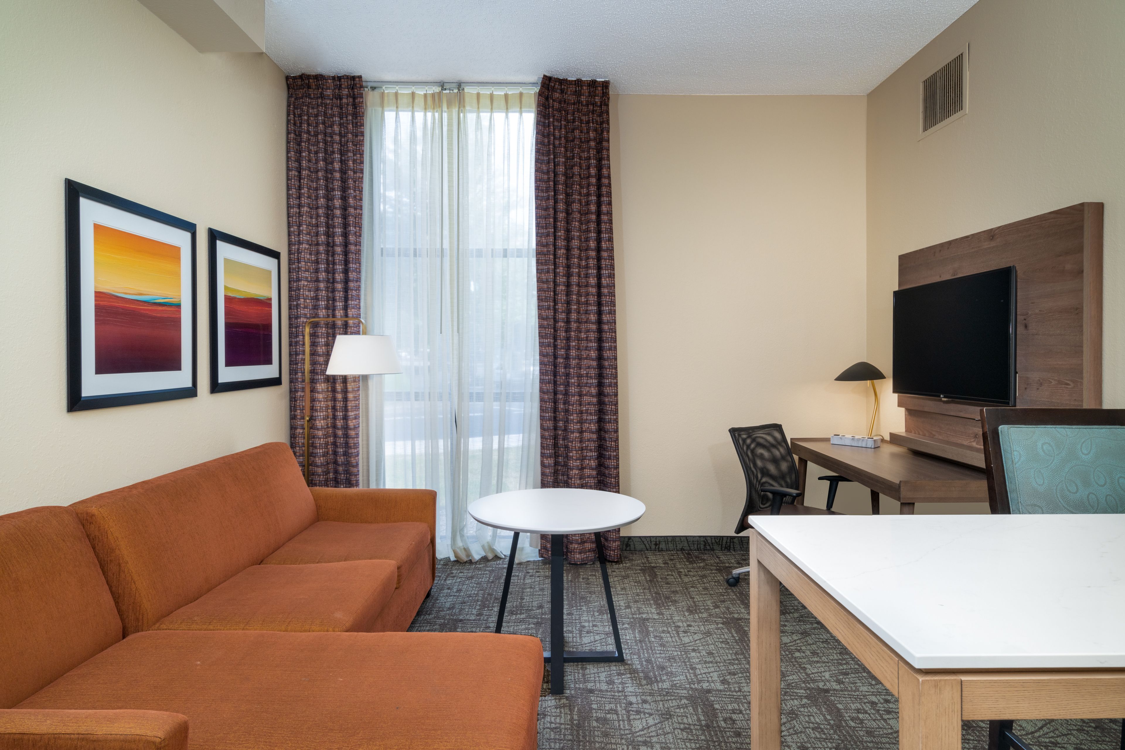 image Inviting living area with artwork, ample seating, and dining space.