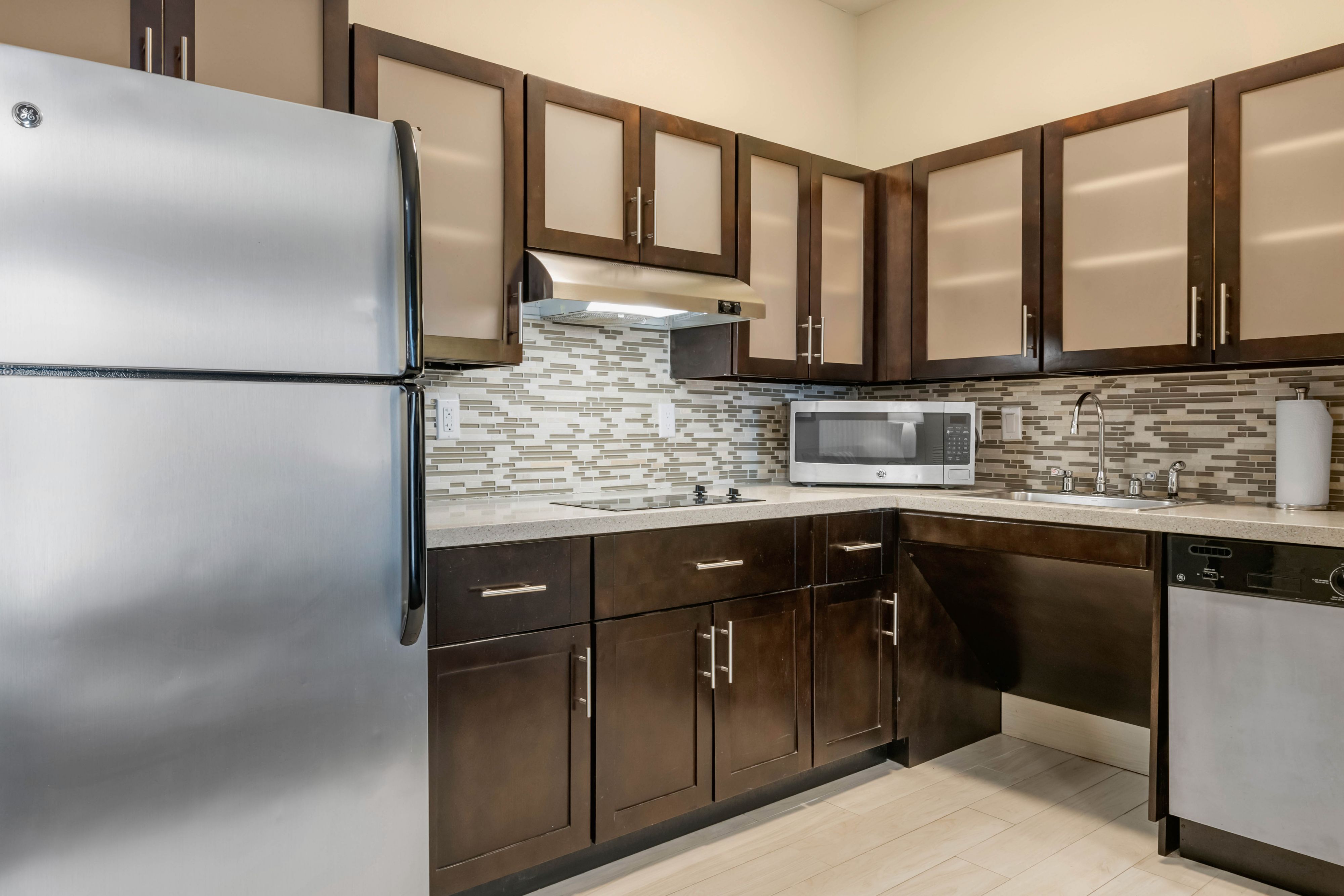 image Stylish kitchen equipped with modern appliances and ample storage.