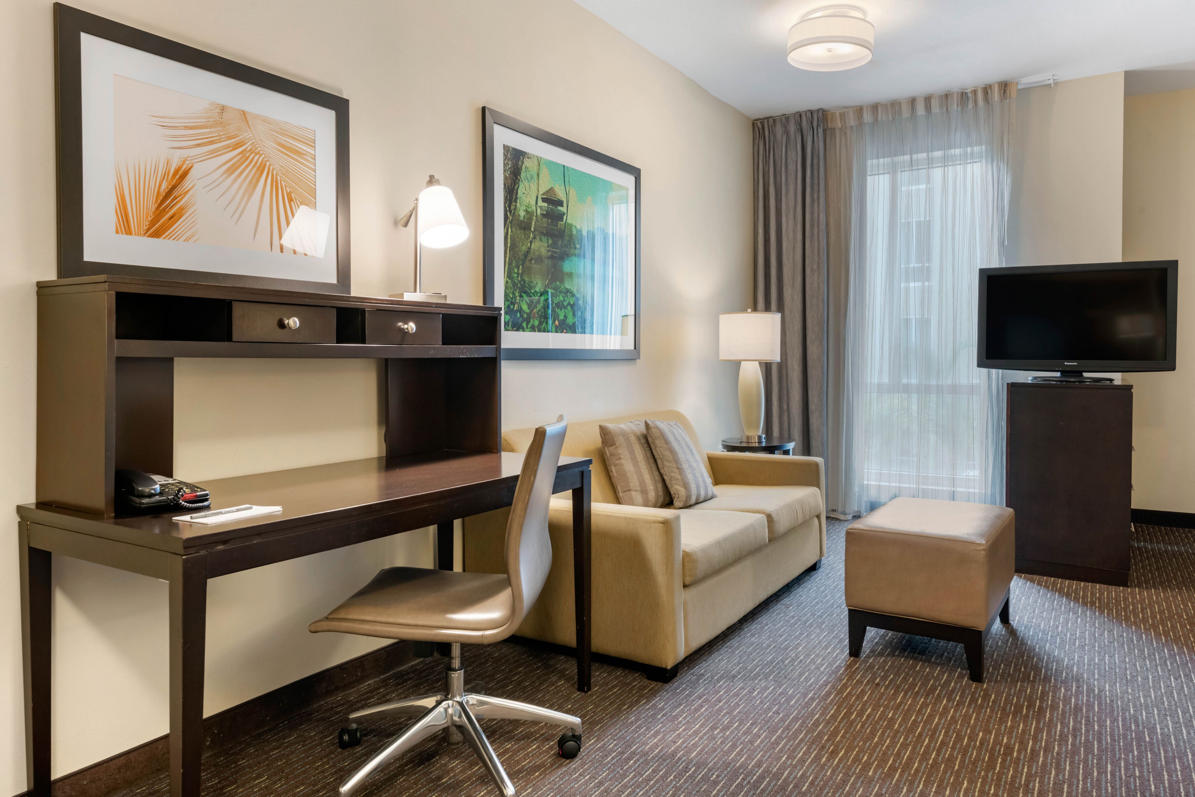 image Inviting living area with comfortable sofa and workspace.