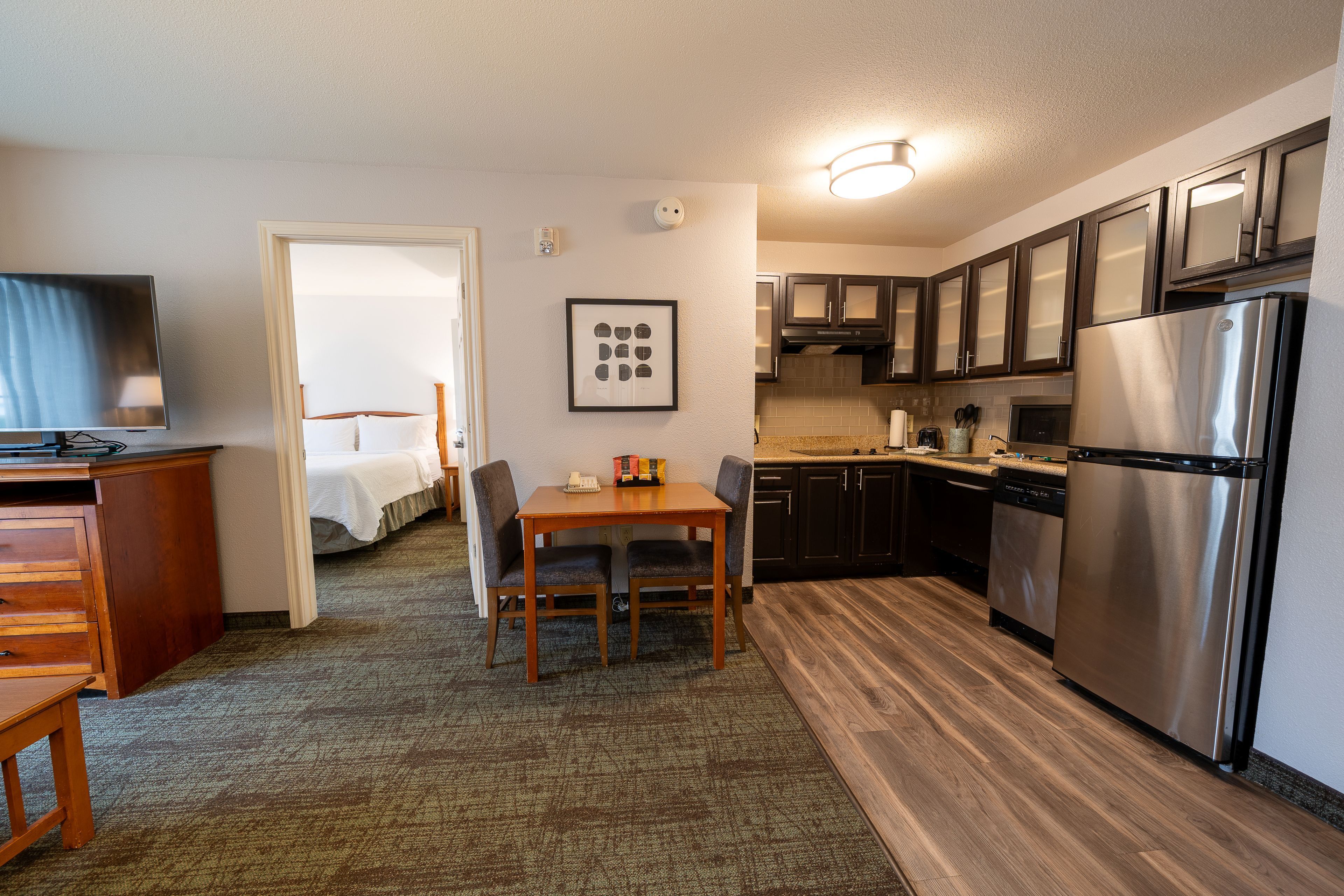 image Open kitchen and dining area with modern appliances.