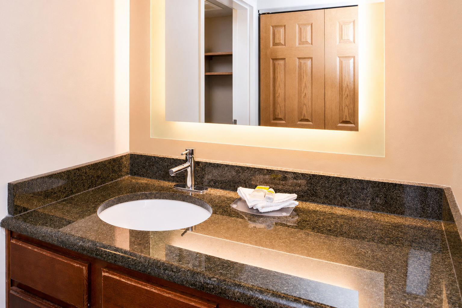 image Modern bathroom vanity with stylish lighting and fresh towels.