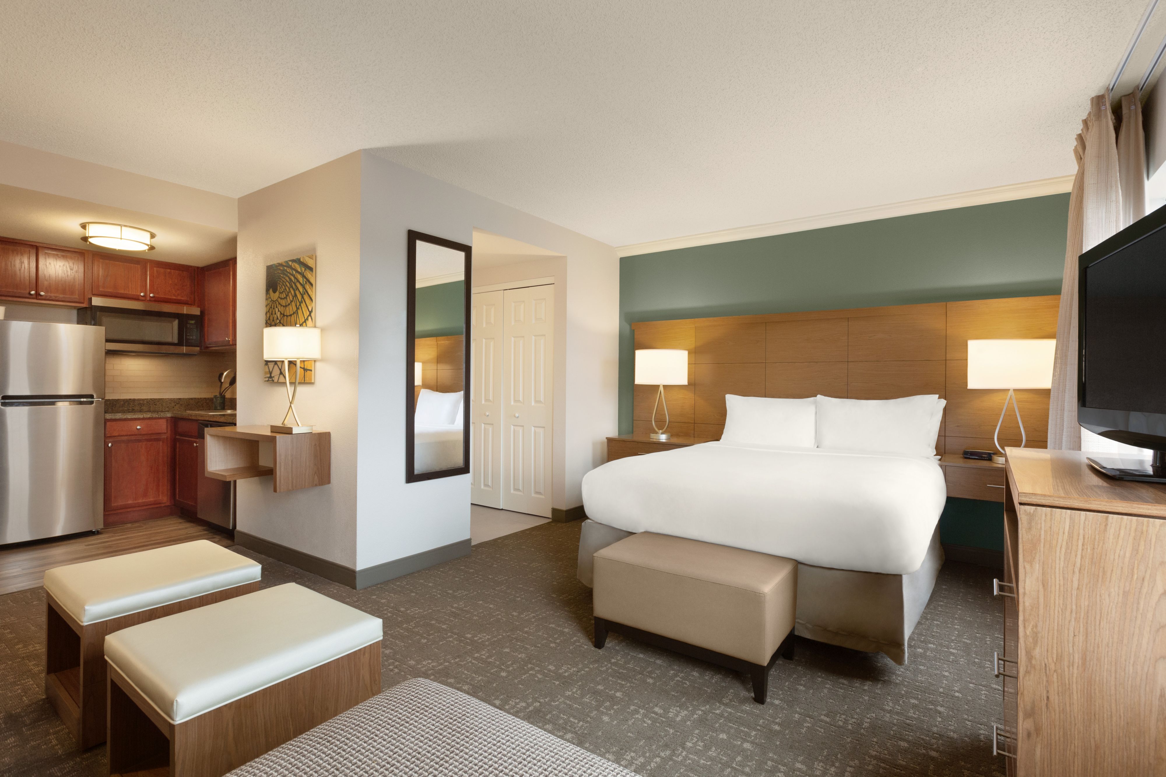image Spacious studio suite with modern furnishings and ample seating.