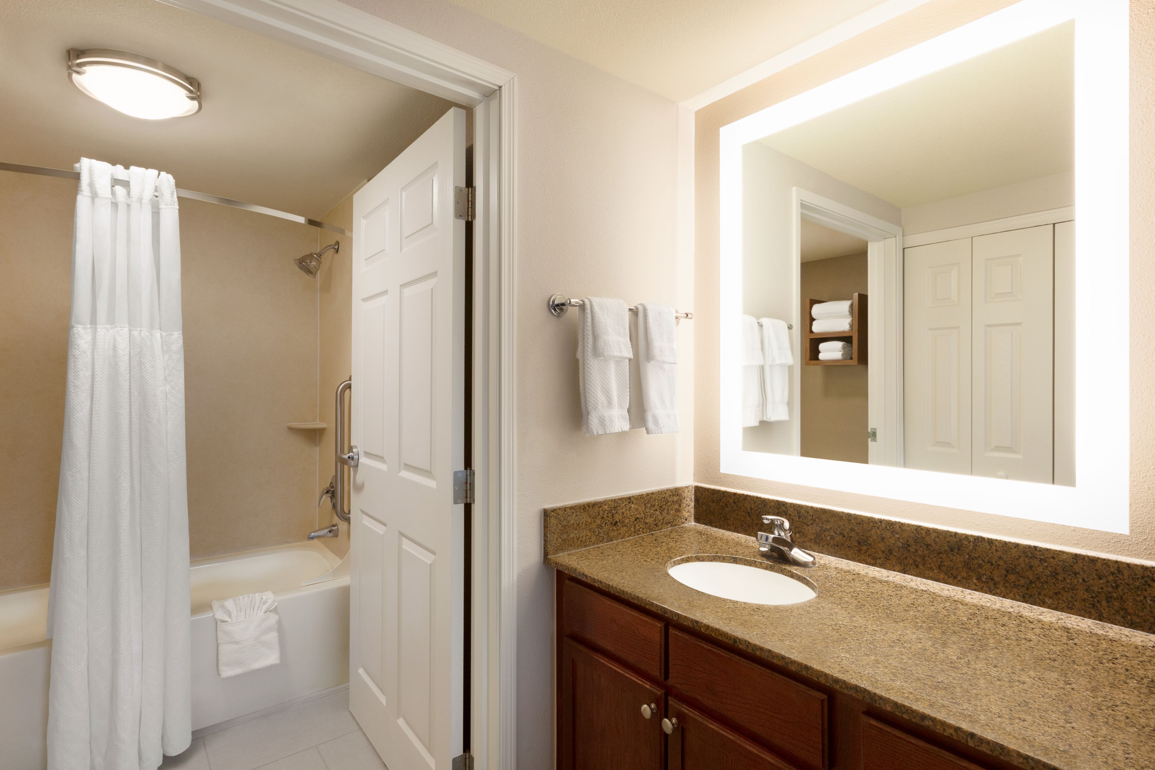 image Clean bathroom with modern fixtures and fresh towels.