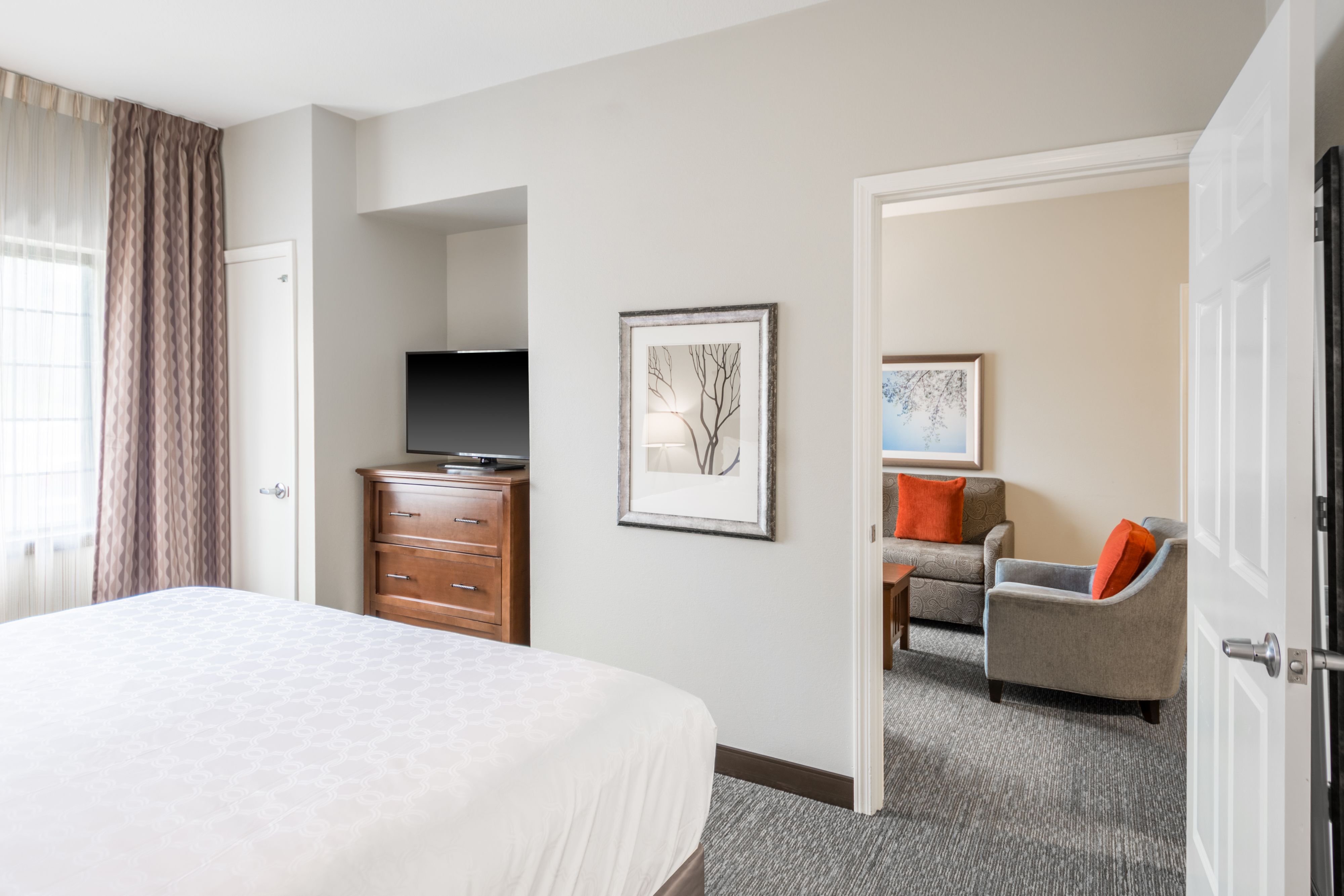 image Queen bedroom with large bed, flat-screen TV, and dresser.