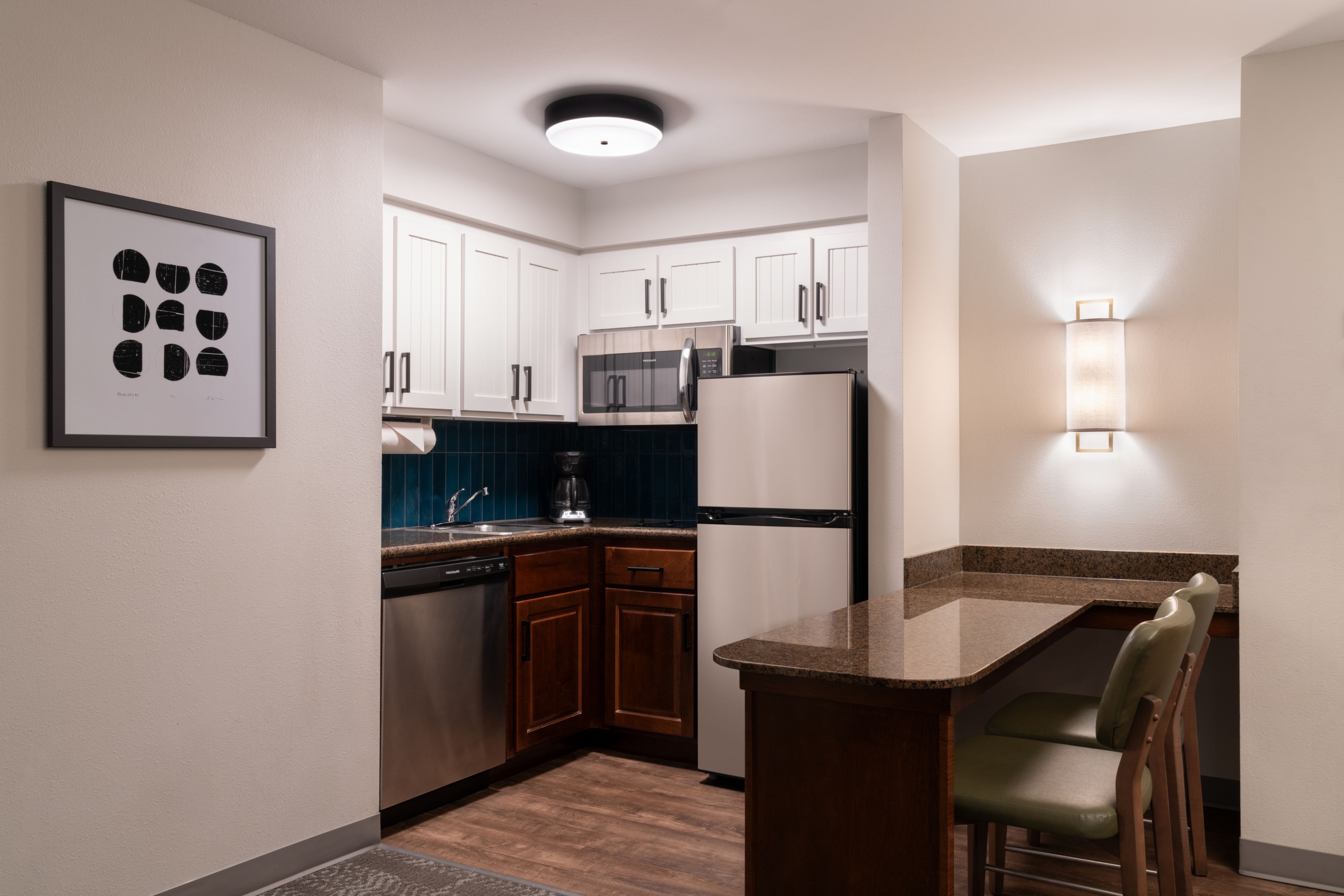 image Fully equipped kitchen with stainless steel appliances and seating.