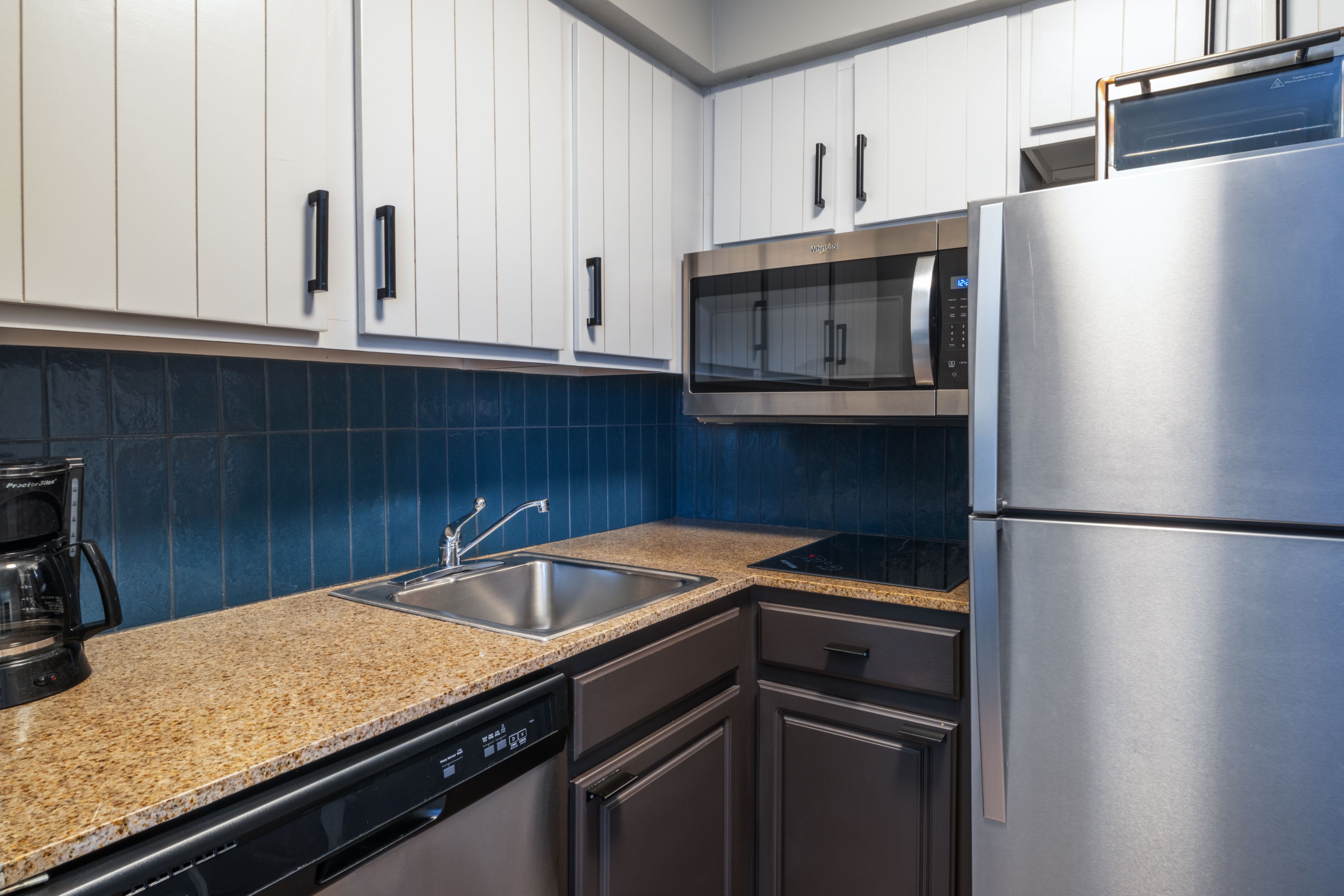 image Kitchen with stainless steel appliances and granite countertop.