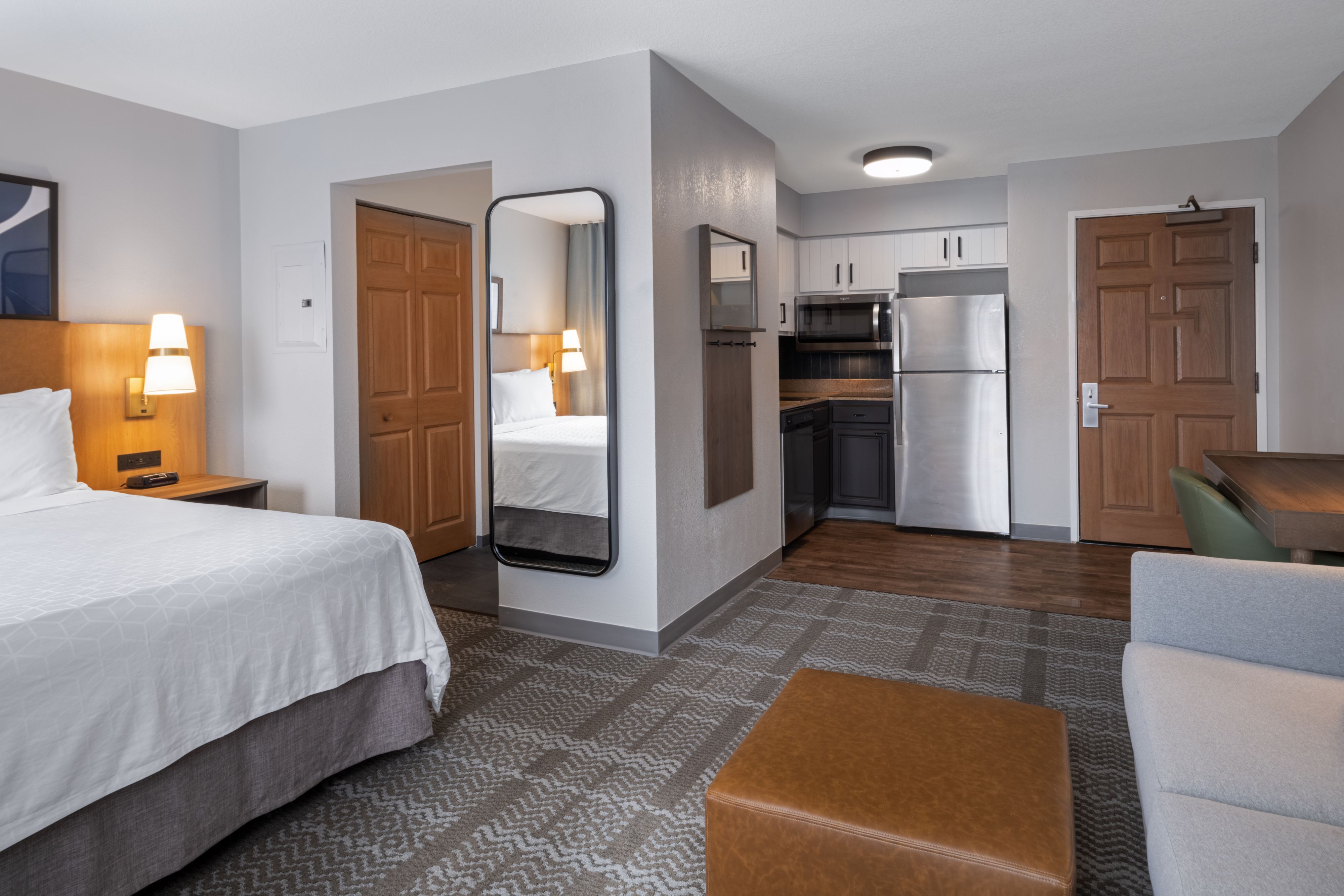 image Queen studio suite with open-plan living and sleeping area.