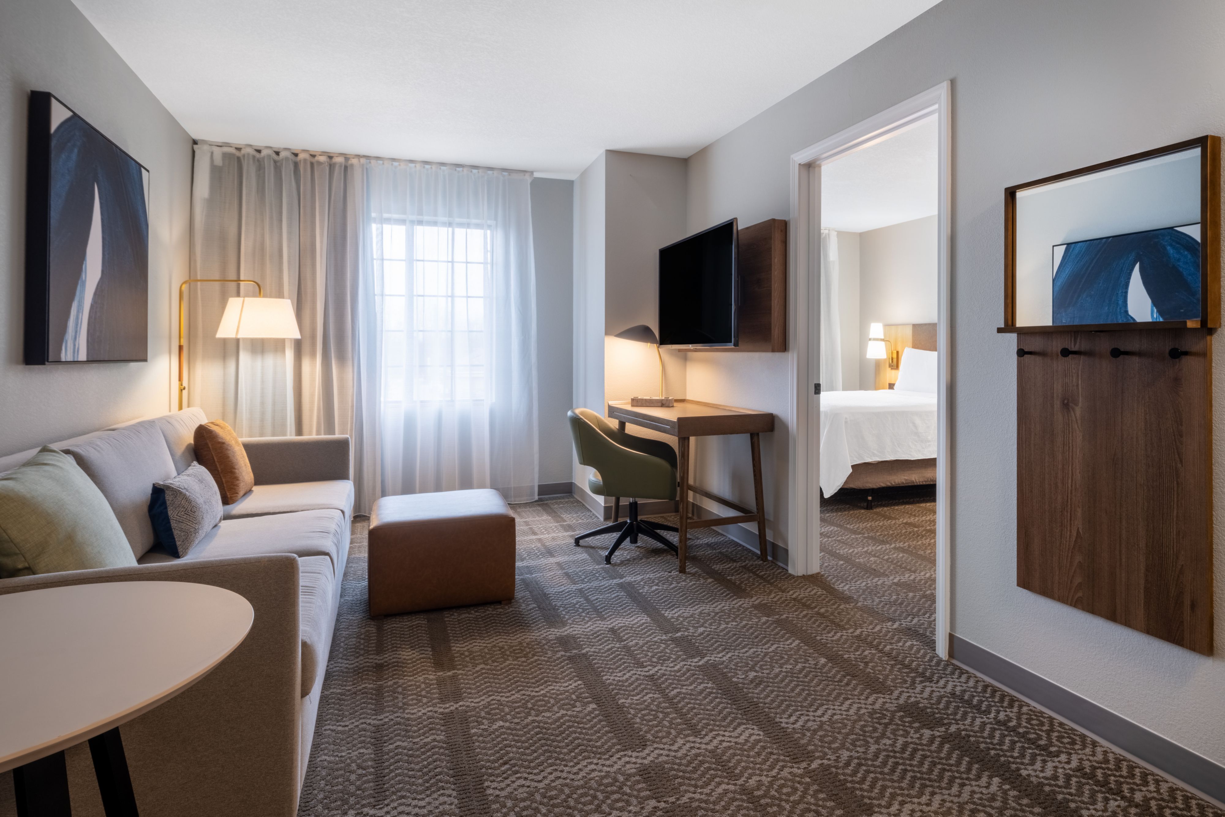 image One-bedroom suite living area with pull-out sofa and TV.