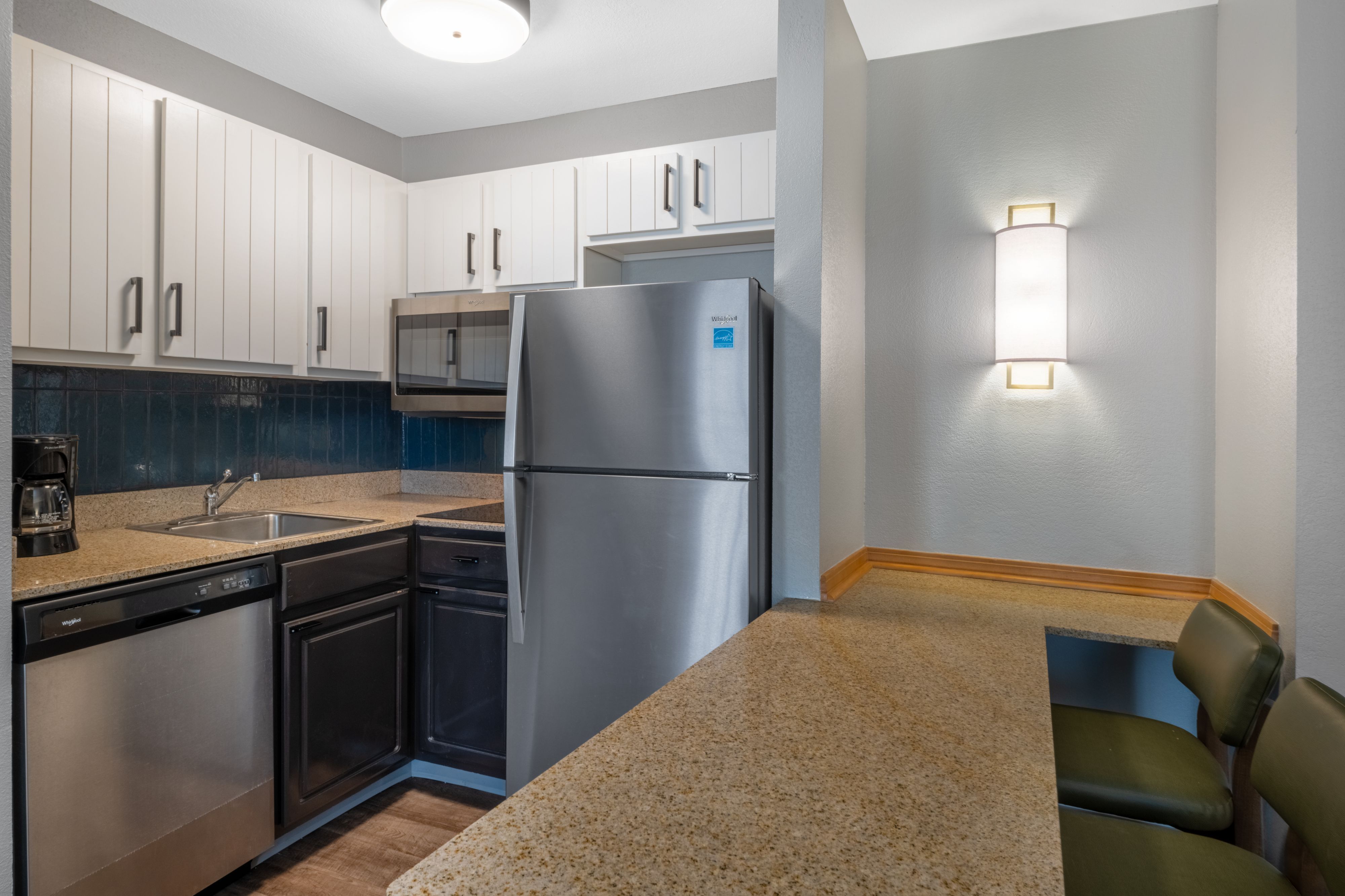 image Kitchen with stainless steel appliances and granite countertop.