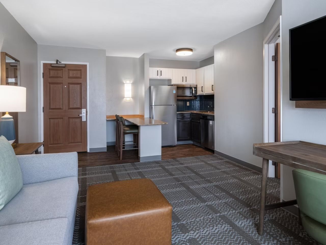 image Living area with kitchen and sofa.