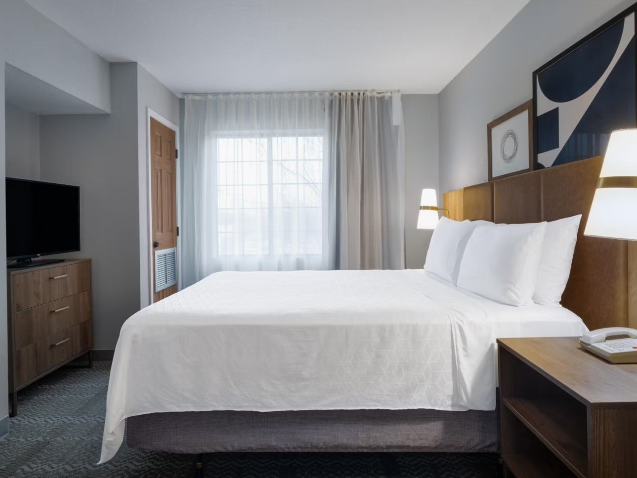 image Bedroom with queen bed and large window.