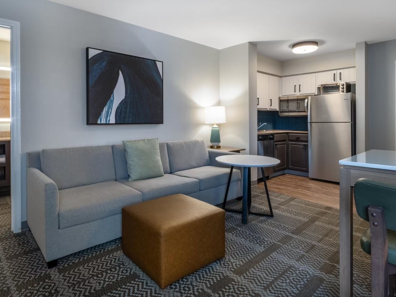 image Relaxing living area with plush sofa and dining table for shared meals.