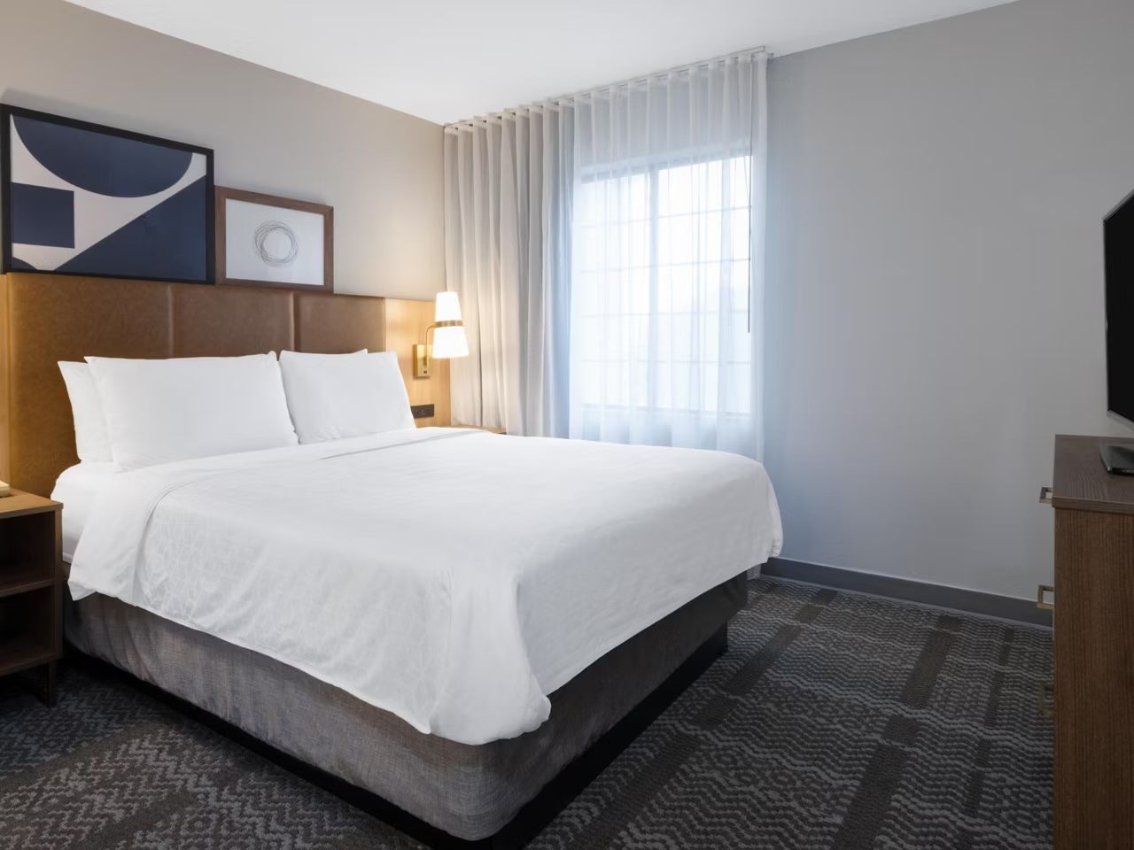 image Restful bedroom with queen bed and plenty of natural light.