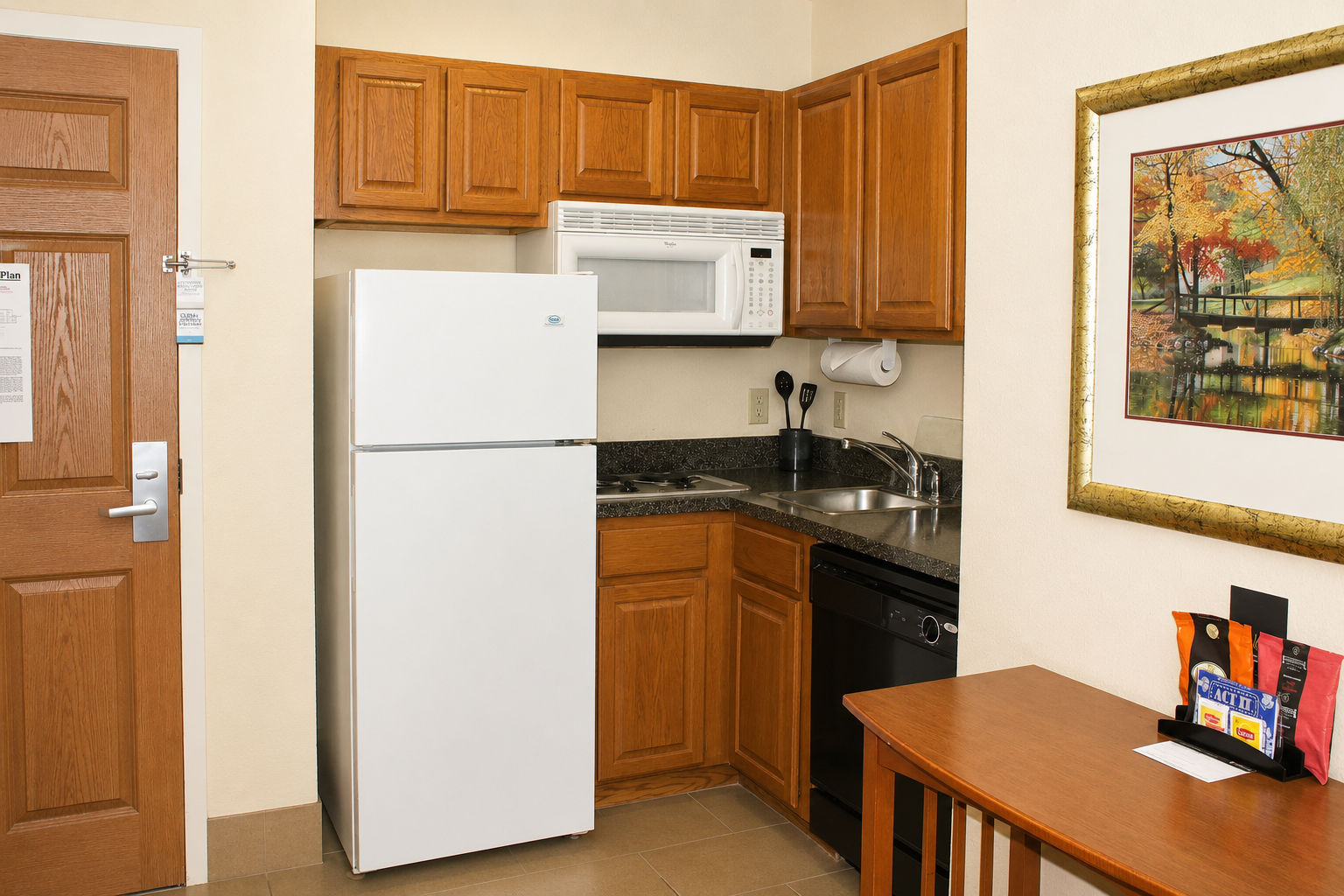 image Full kitchen with refrigerator, stove, oven, microwave, and dishwasher — everything needed for a self-sufficient extended stay