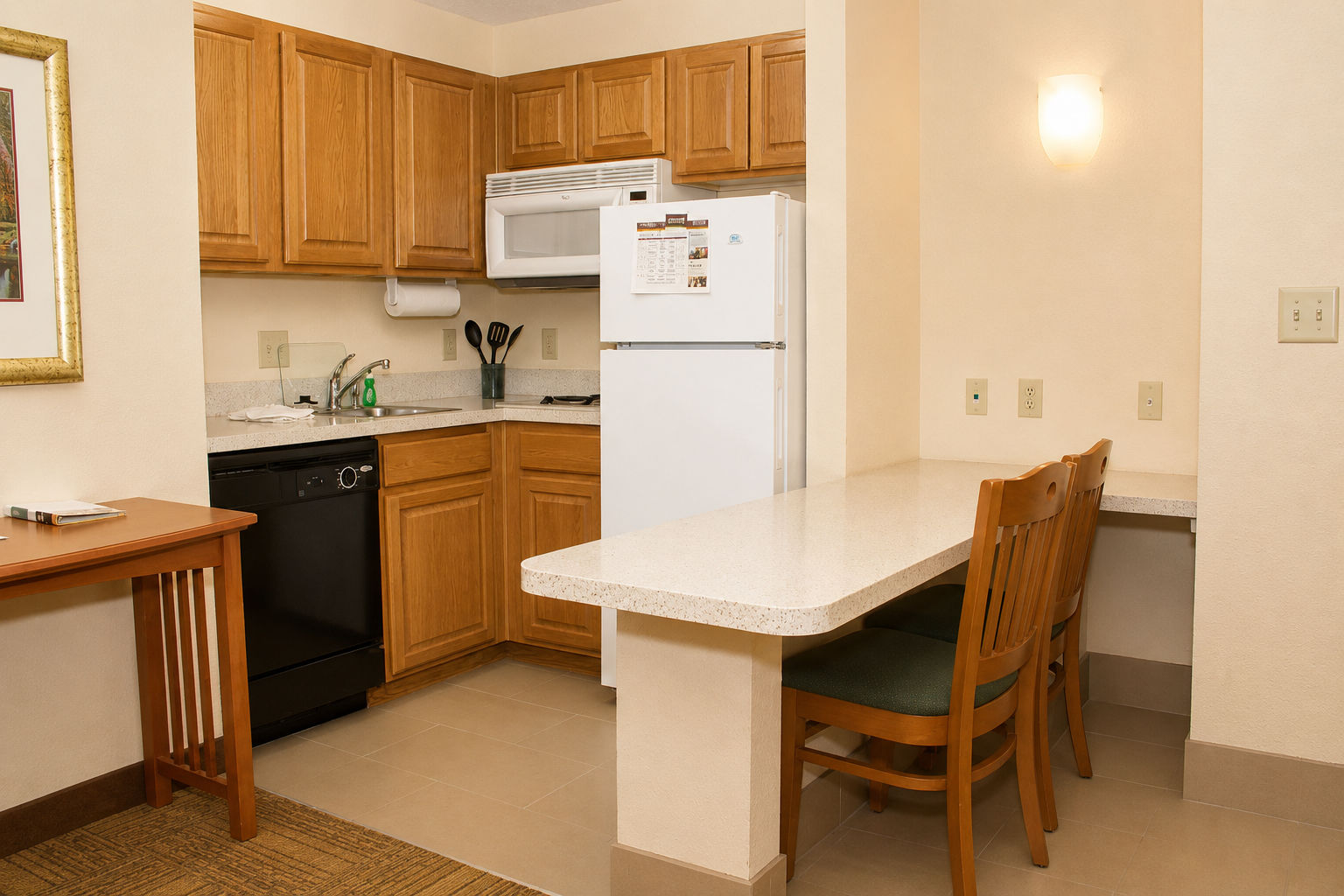 image Fully equipped kitchen with modern appliances and seating for two.