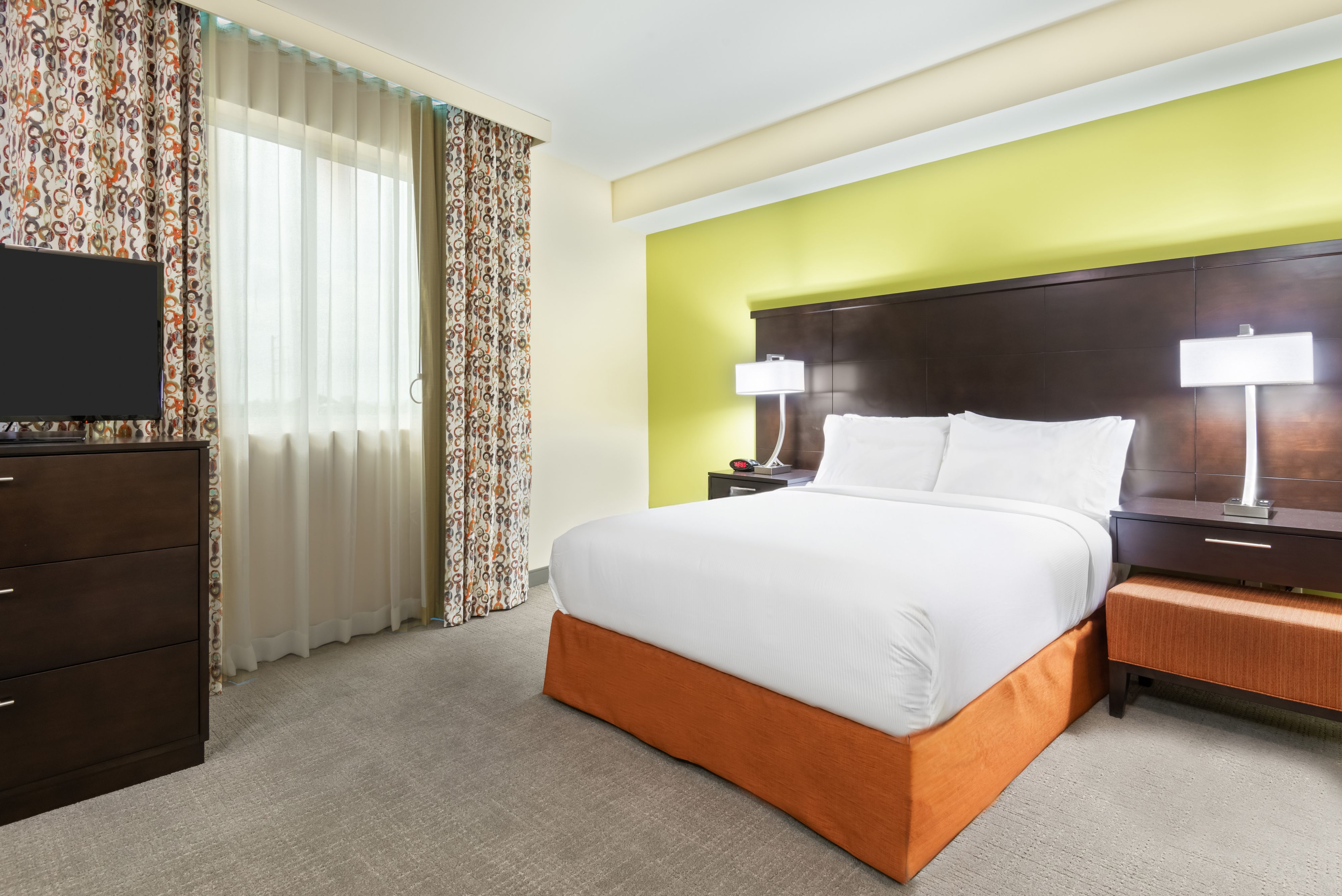 image Sink into comfort in the inviting bedroom, with a king-sized bed and bright, cheerful decor.