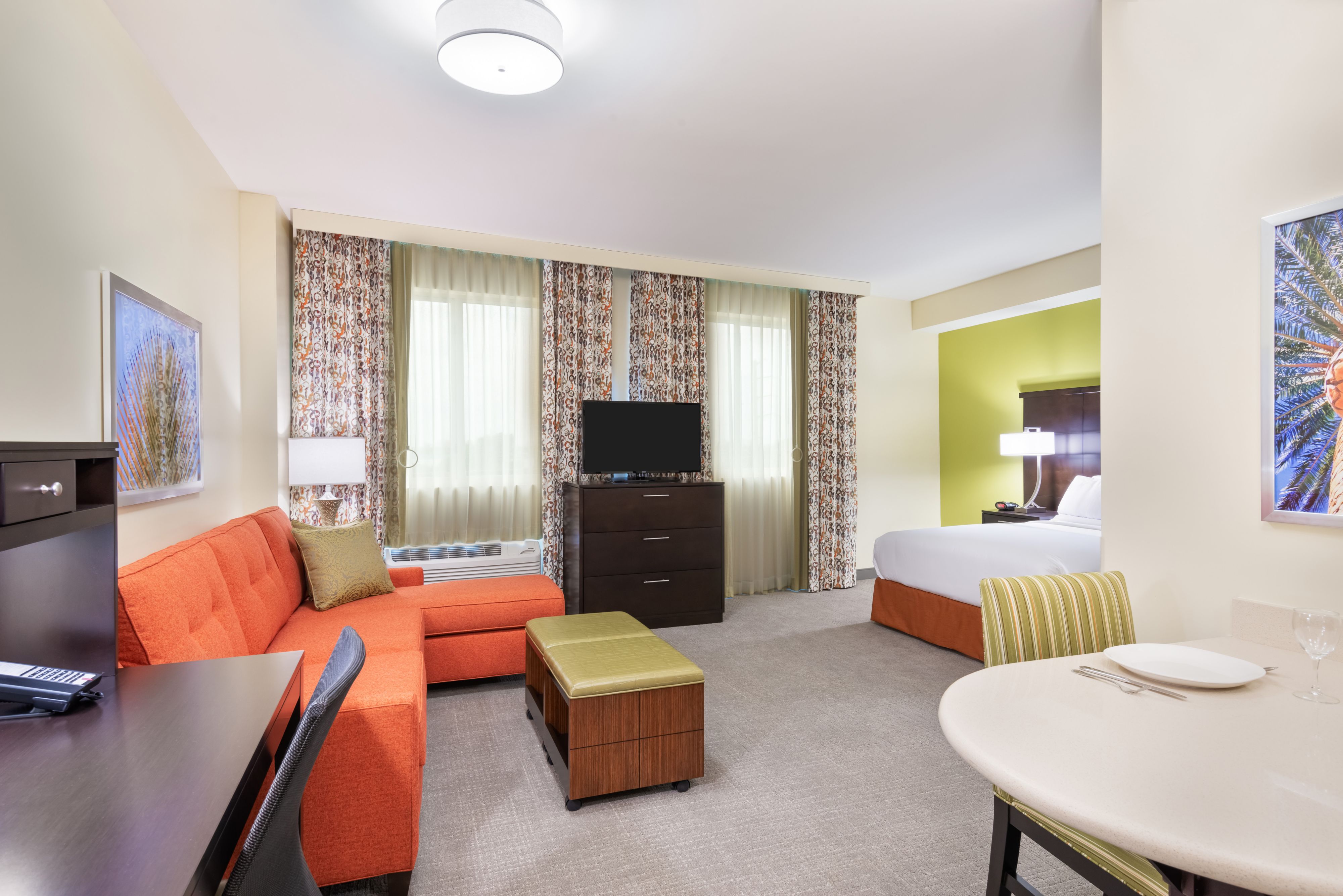 image Relax in this cozy living area with vibrant décor and a queen bed, perfect for unwinding after your adventures.