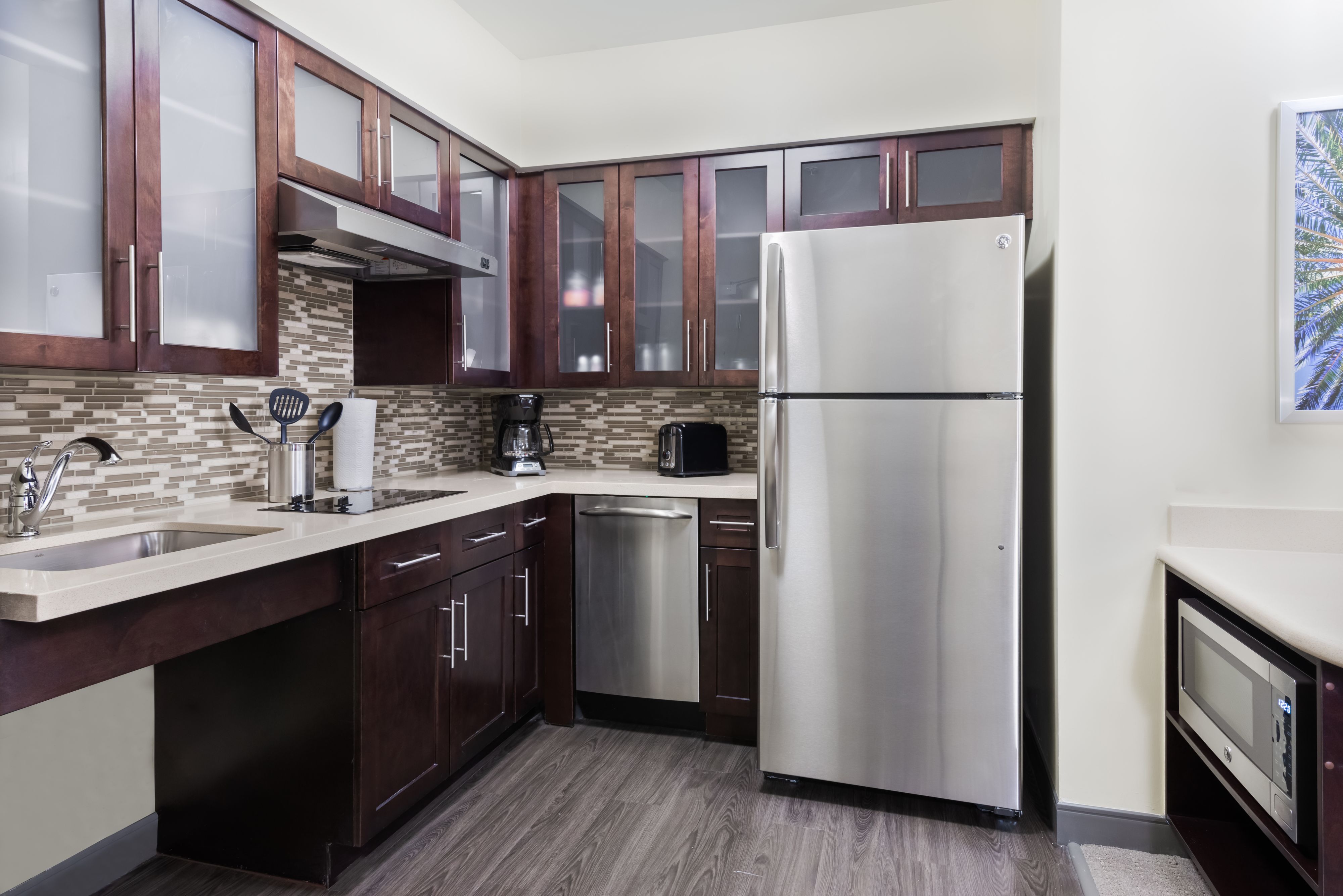 image Cook with ease in this modern kitchen, featuring sleek cabinets and stainless steel appliances.