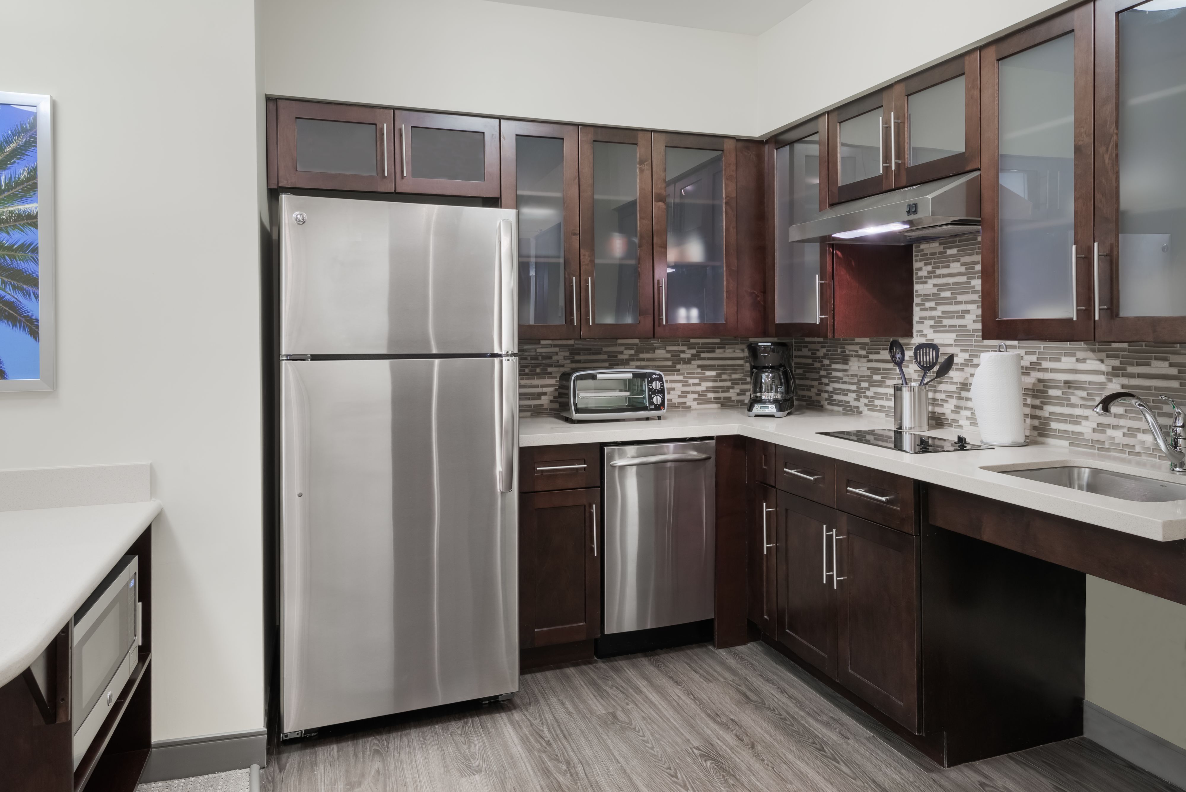 image Create culinary delights in a fully equipped kitchen, featuring sleek appliances and ample counter space.