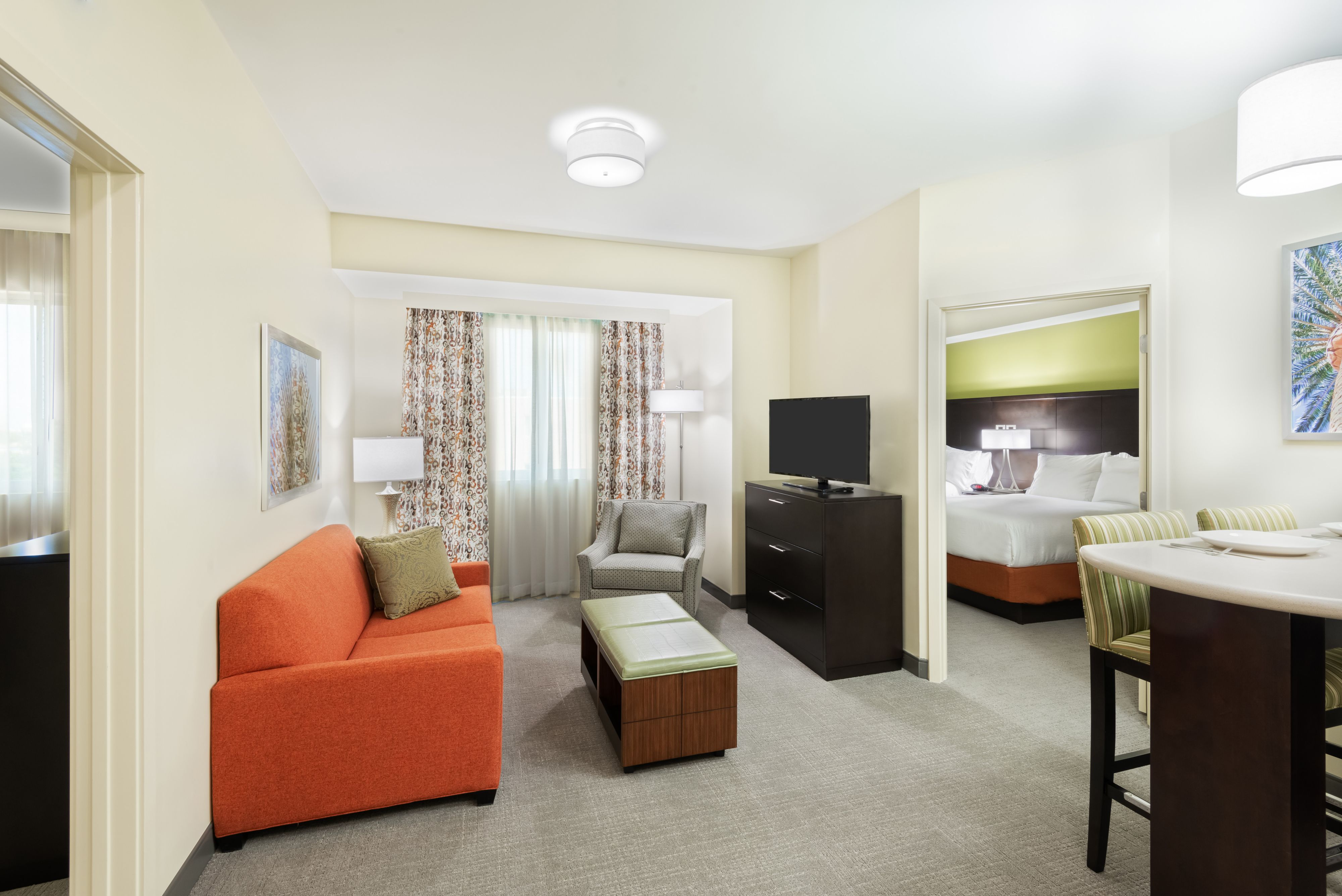 image Relax and unwind in this spacious living area, complete with a comfy sofa and modern entertainment options.