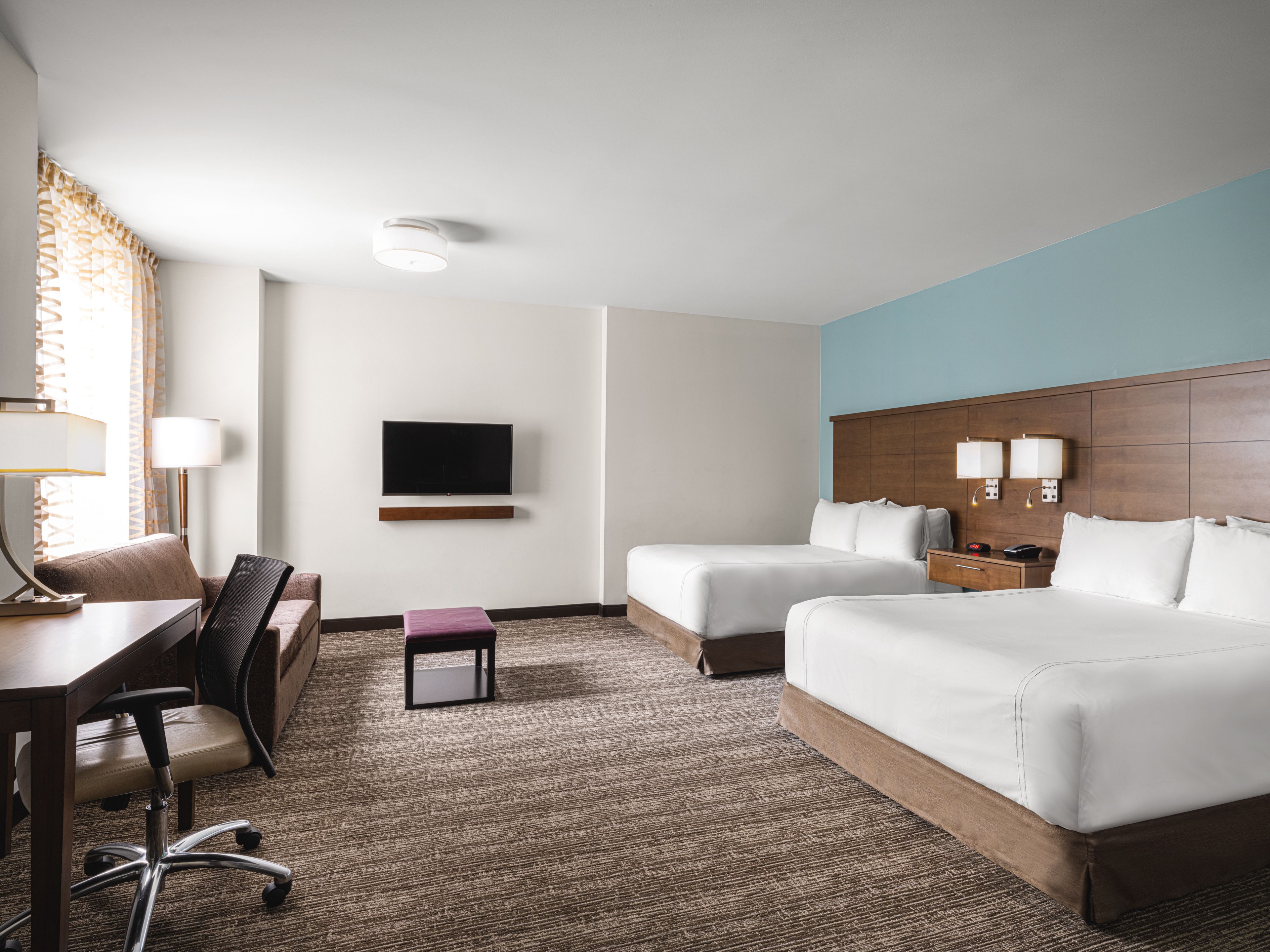 image Studio suite with two queen beds, desk, and TV.