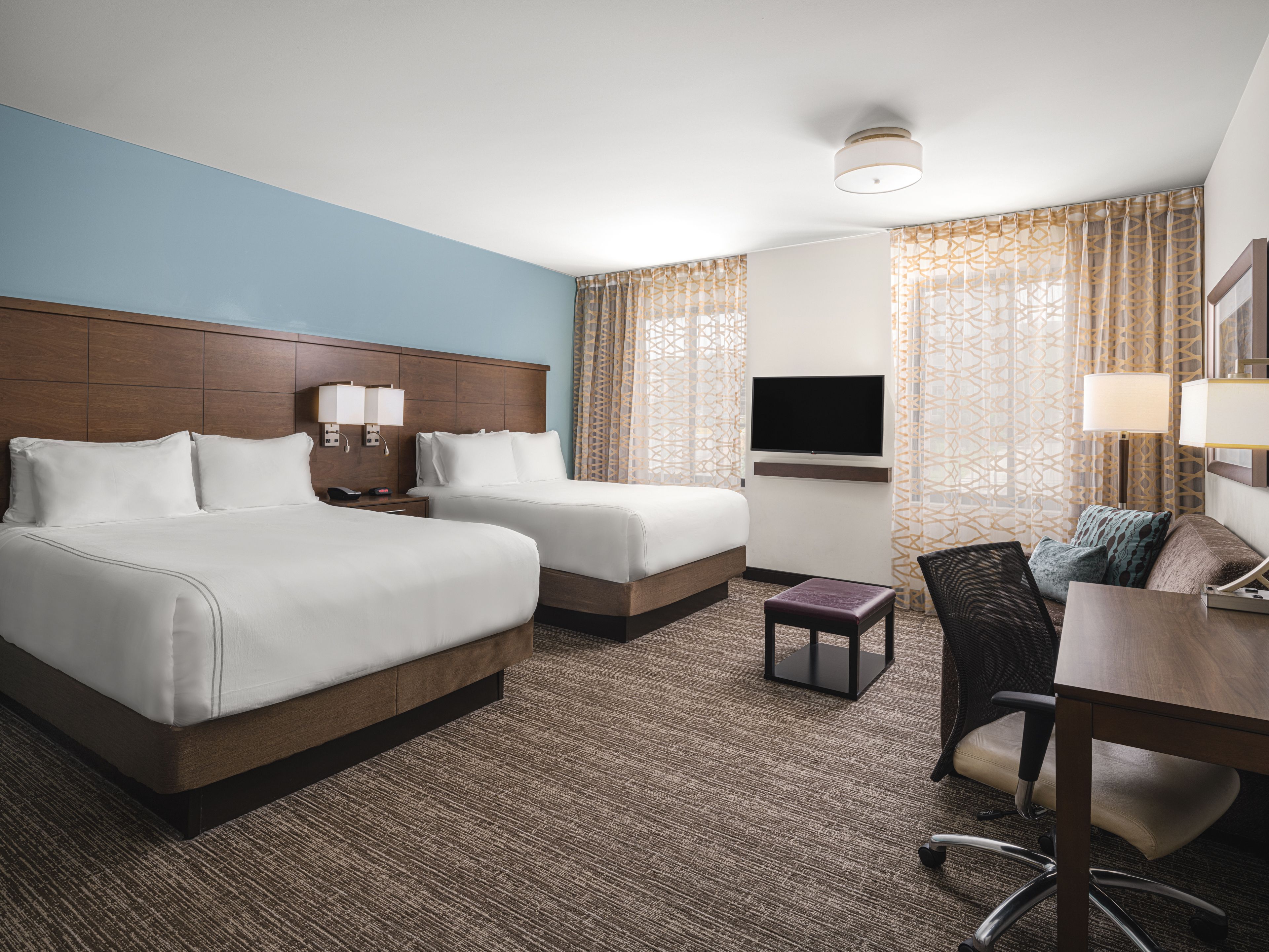 image Studio suite with two queen beds, desk, and seating area.