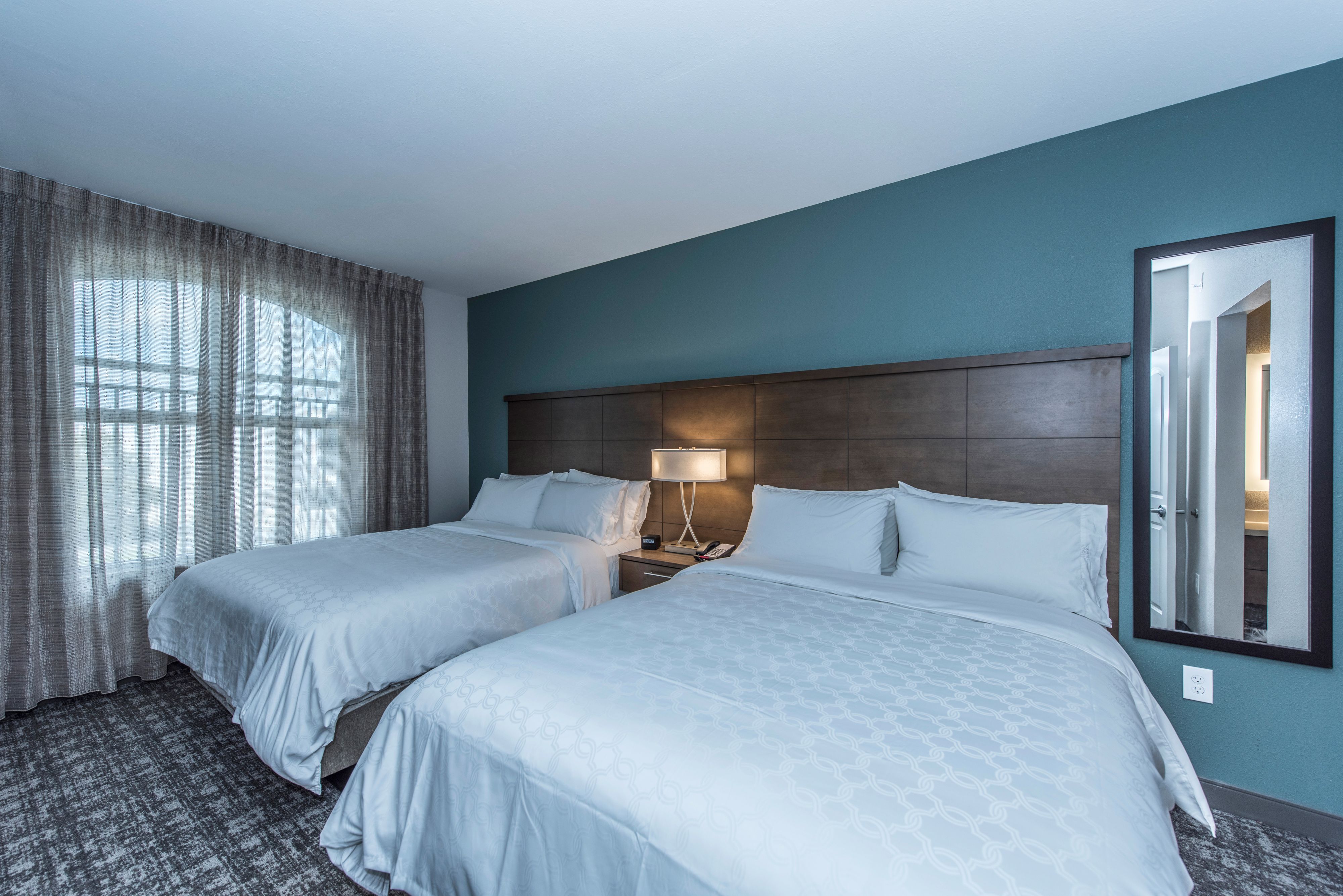 image Bright room with two queen-sized beds, perfect for families.