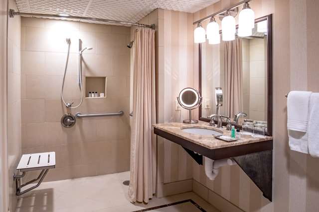 image Experience tranquility in the accessible bathroom, featuring a roll-in shower and thoughtful design.