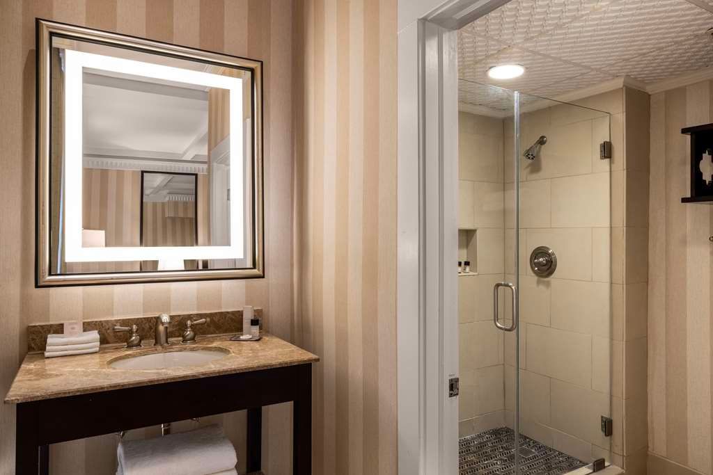 image Brighten your morning routine with a beautifully lit shower and elegant vanity.