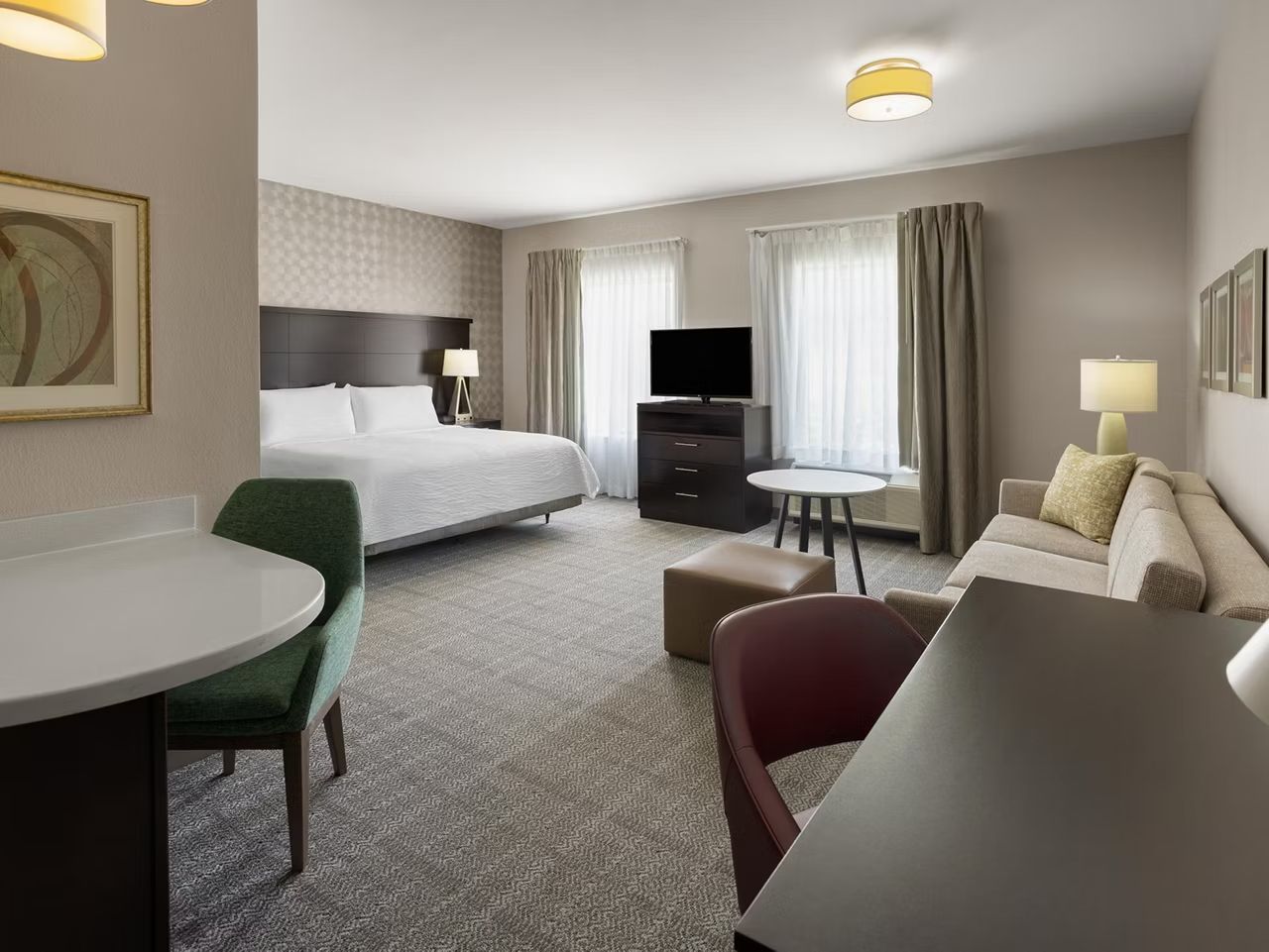 image Settle into a bright studio featuring a plush king bed, ideal for winding down after a day of exploring.