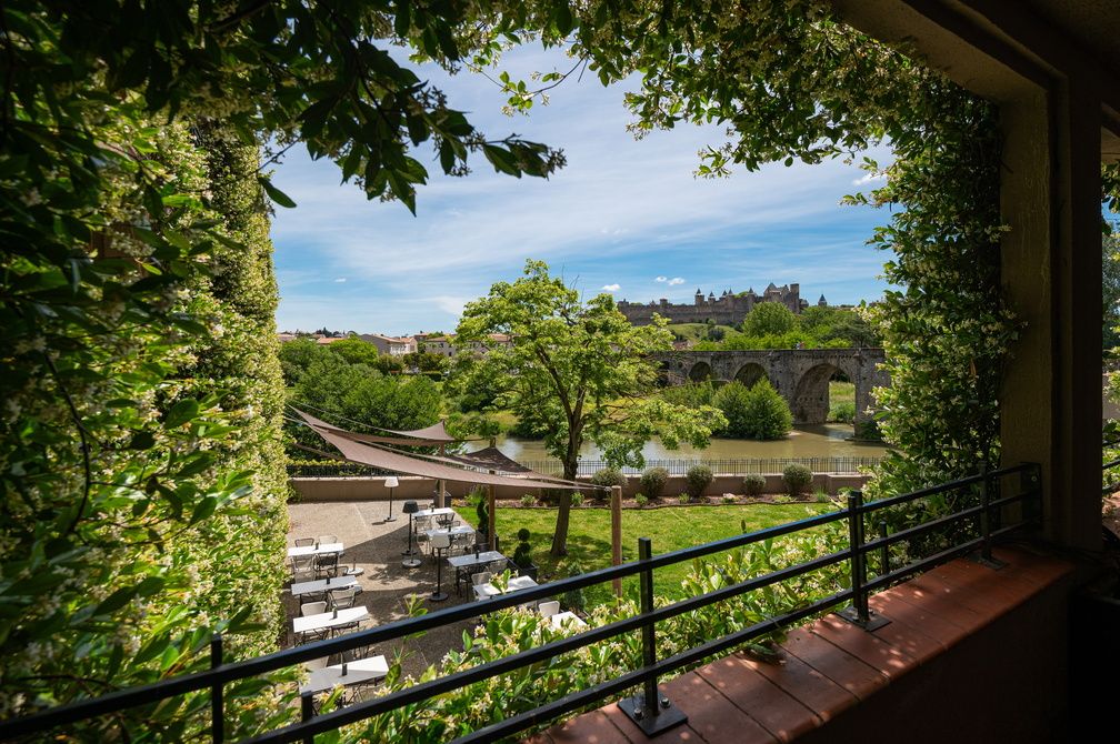 image Views of the Aude River and the Cité Médiévale framed by the hotel's ivy-covered walls — steps from your room.