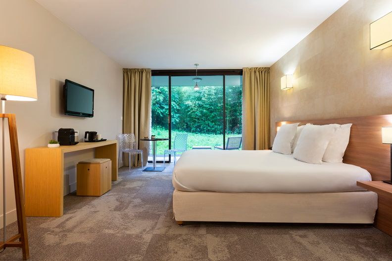 image The Supérieure rooms are located in the estate's contemporary building, offering a sleek, modern aesthetic with warm tones and direct views over the park.