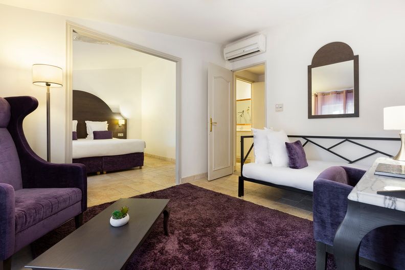 image A comfortable armchair and side table complete the Classique room layout, providing a relaxed corner to unwind with a book or plan the next day's excursions.