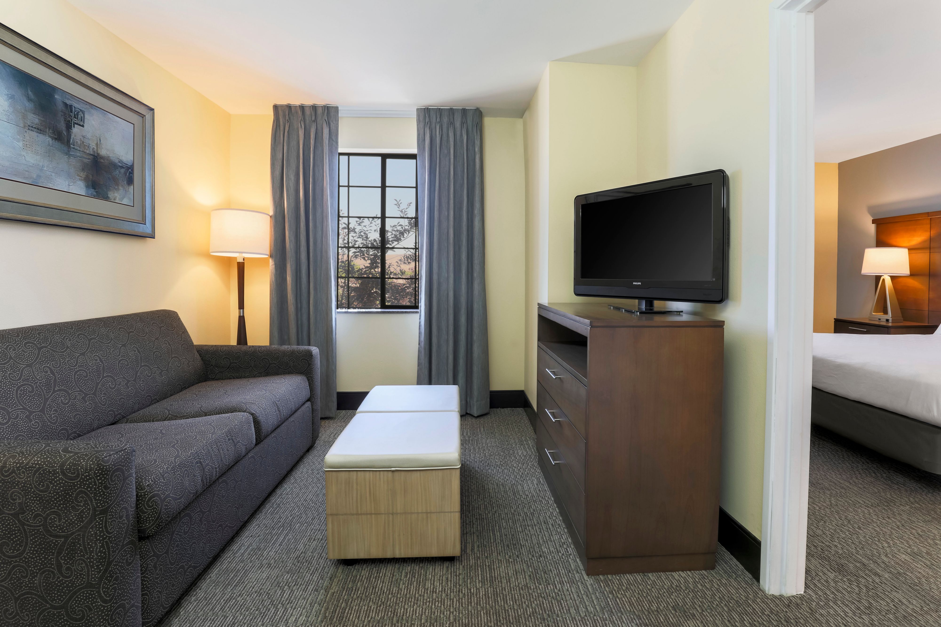 image Unwind in the living area with a comfy sofa and flat-screen TV.