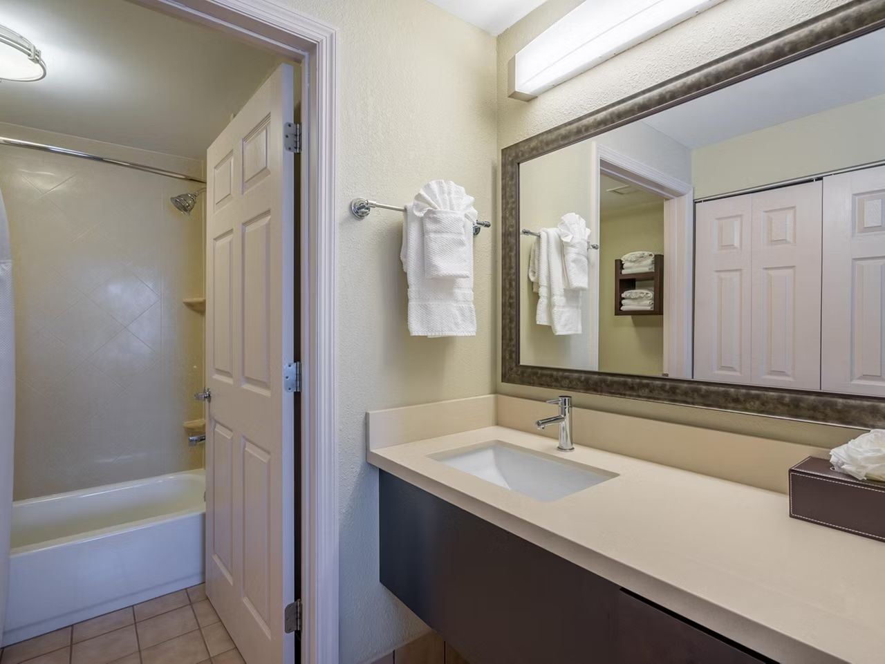image Bathtub, wide vanity counter, and storage for your toiletries — towels and hairdryer included