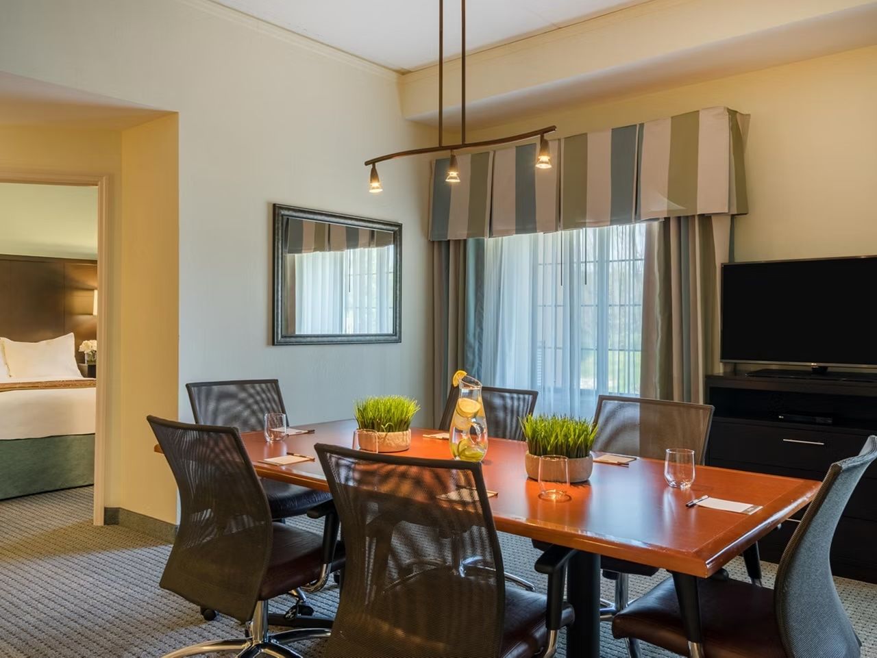 image Wooden conference table with seating for the group, steps from the kitchen and living area