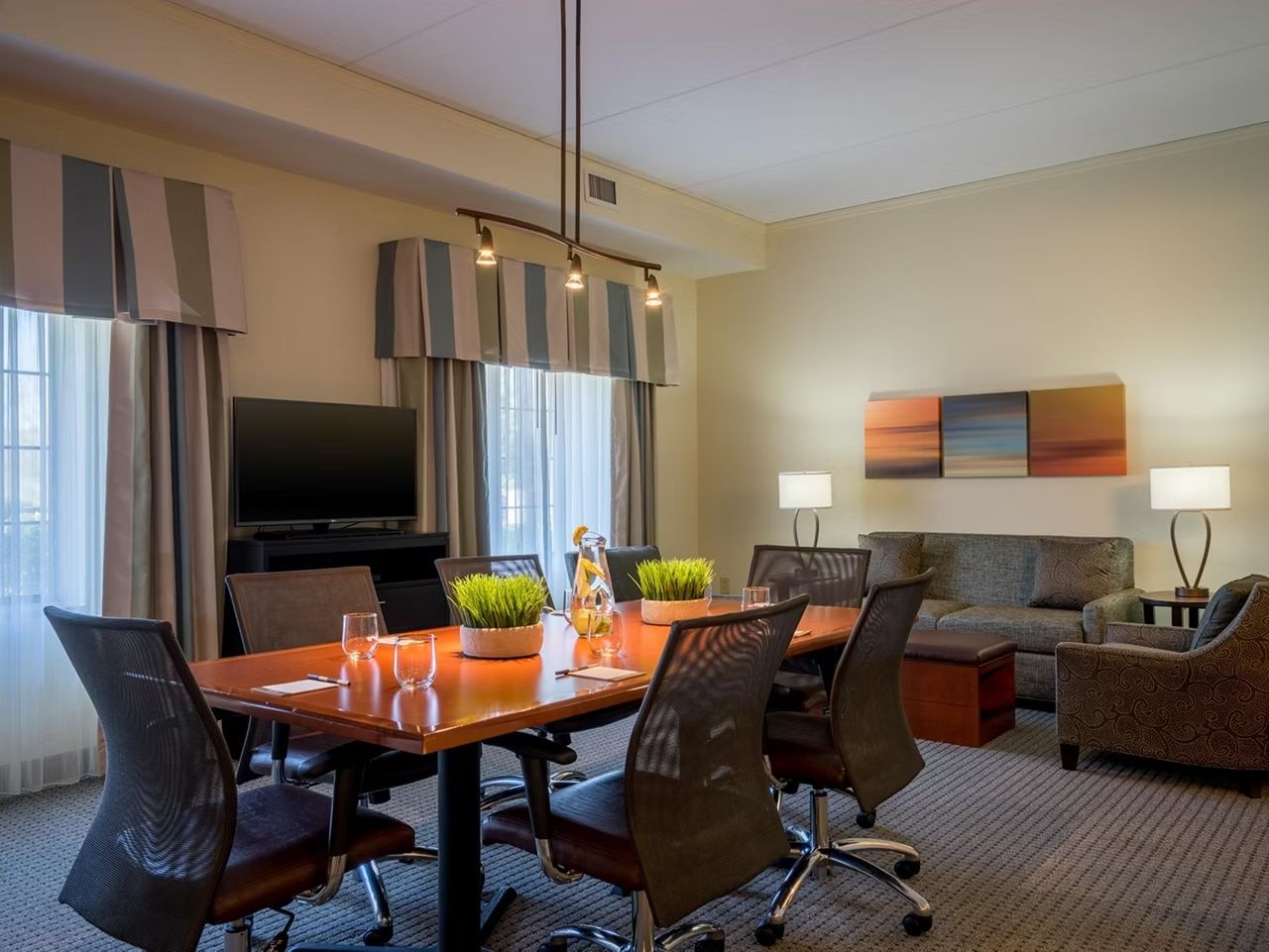 image Dining and conference table seats your group for working sessions or shared meals — windows bring in natural light