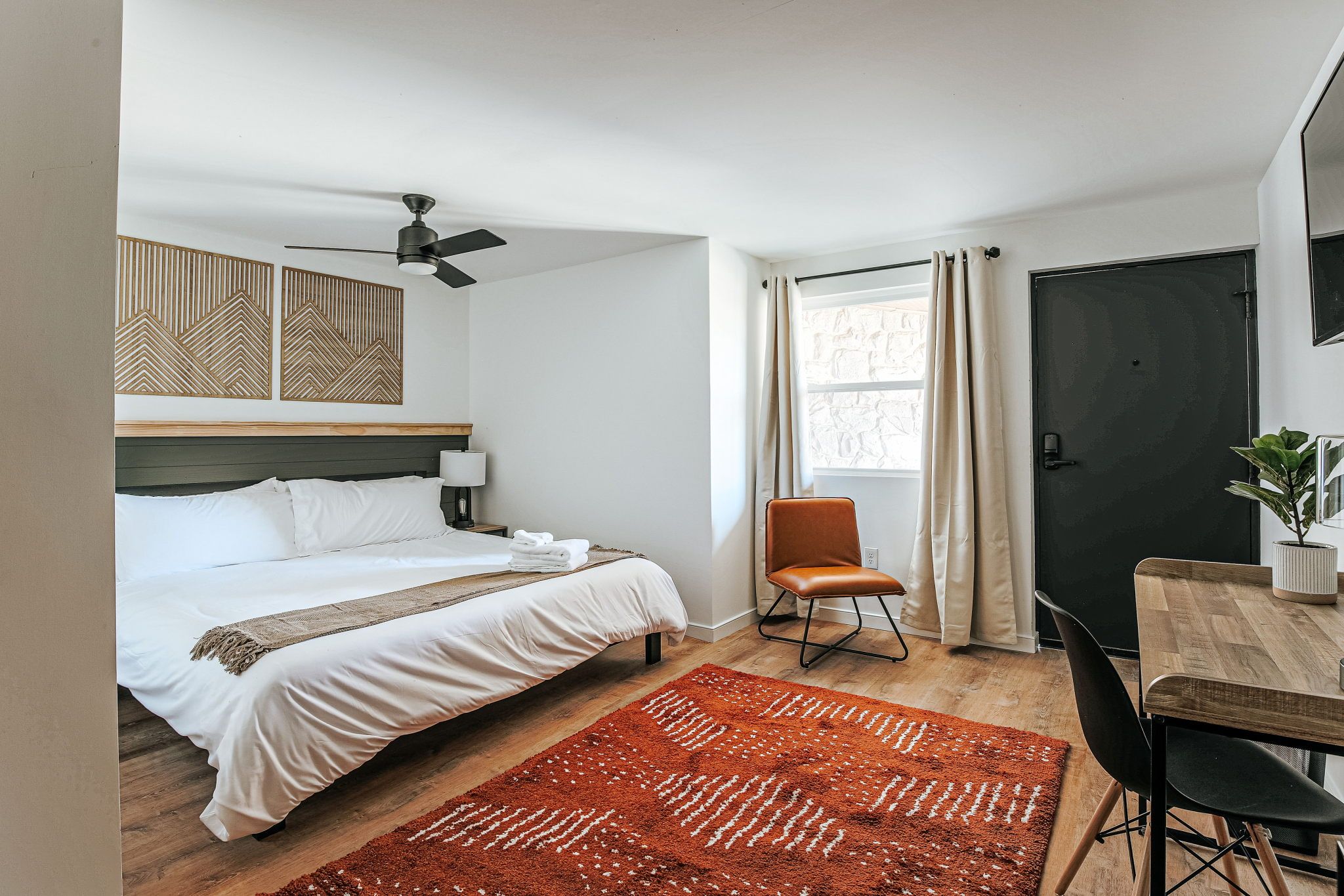 image Enjoy the warmth of natural light filling this inviting room, complete with a comfortable king bed and stylish décor.